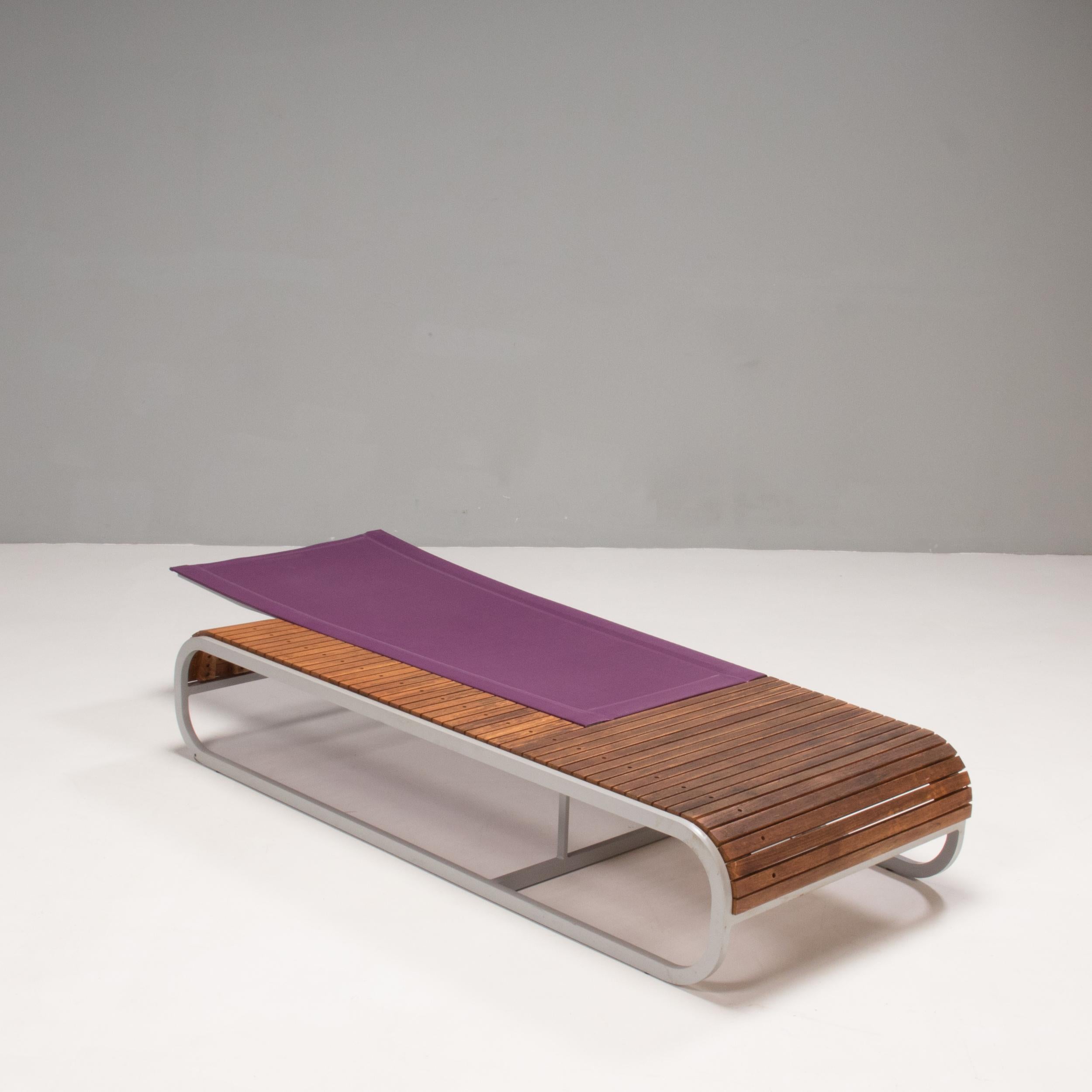 Designed by Thomas Sauvage for EGO Paris, the Tandem sun lounger was awarded the Red Dot design award in 2008.

Constructed from a thermo-lacquered aluminum frame, the sun lounger features a wooden deck surround, with a purple mesh backrest which