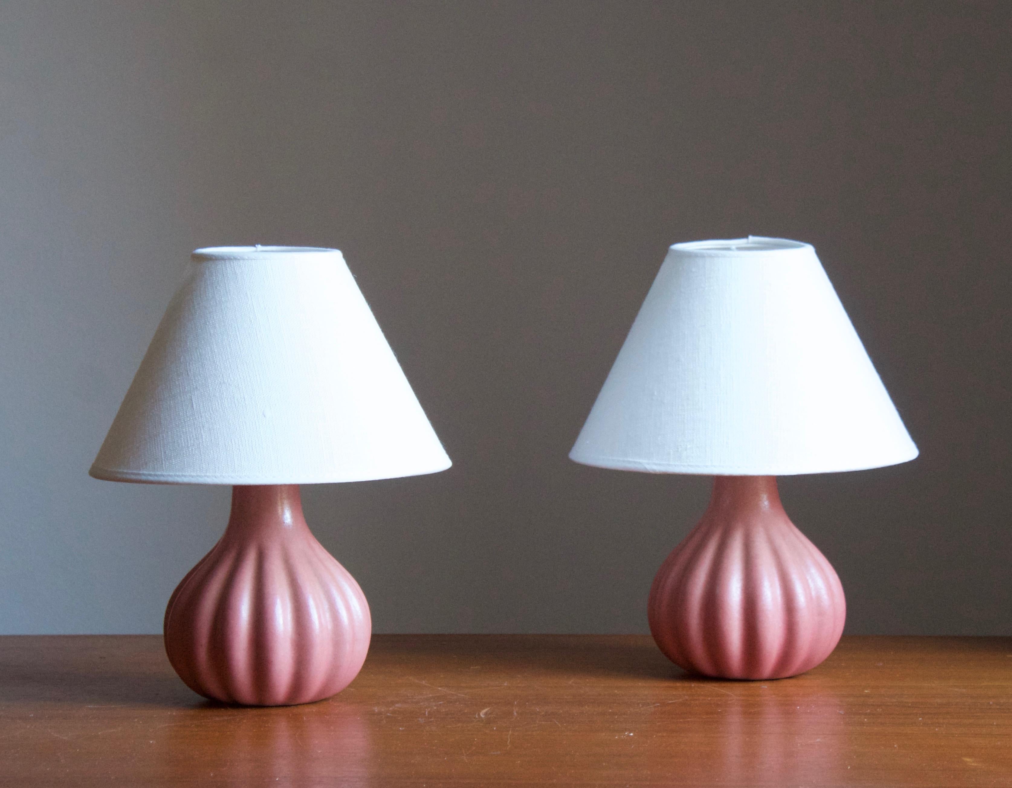 A stoneware table lamps. Produced by Ego Stengods c. 1960s-1970s. Stamped.

Stated dimensions exclude lampshade. Height including socket. Sold without lampshades.

Glaze features a pink color.

Other ceramicists of the period include Axel Salto,