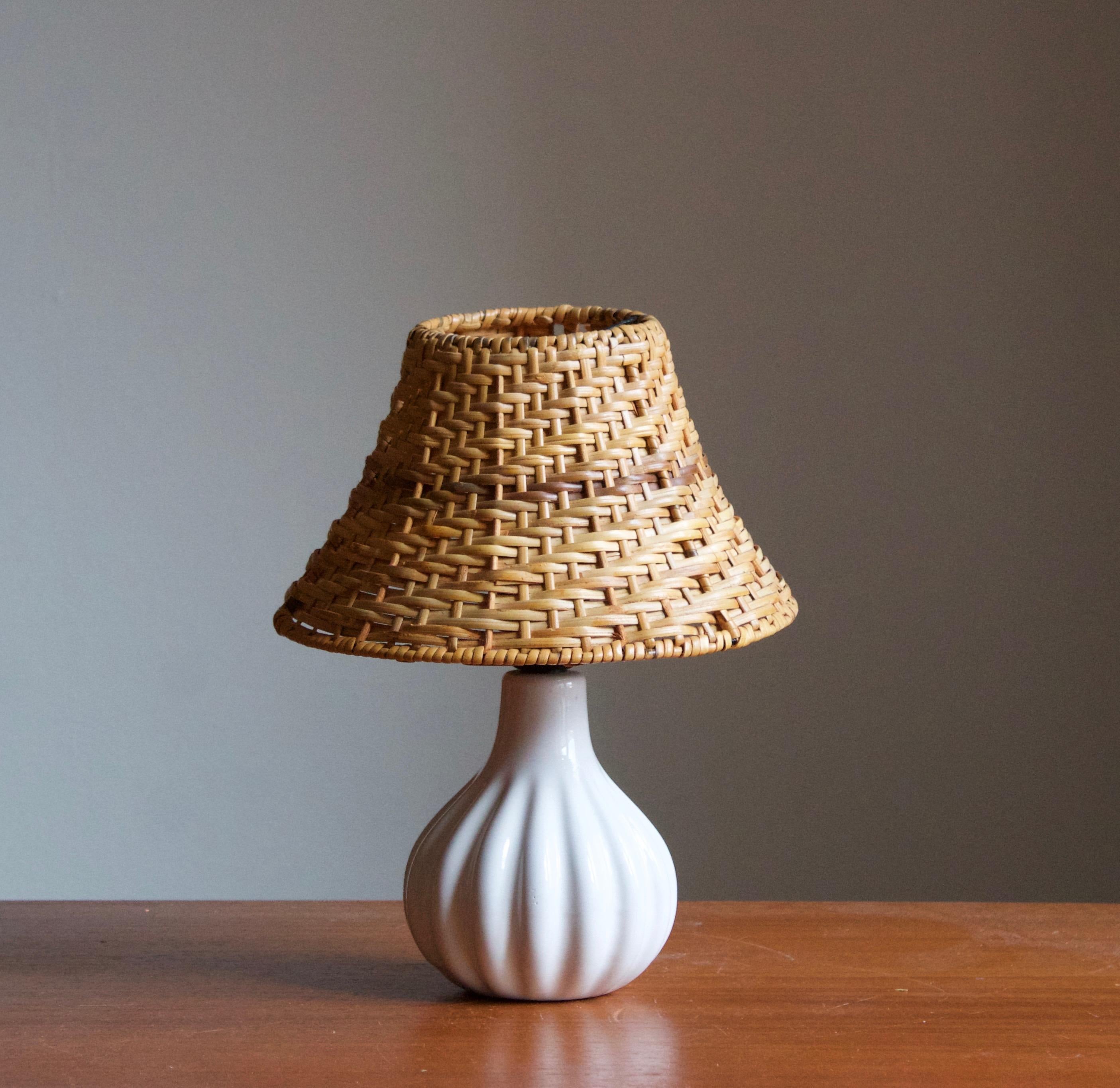 A stoneware table lamps. Produced by Ego Stengods c. 1960s-1970s. Stamped.

Stated dimensions exclude lampshade. Height including socket. Rattan lampshade available upon request.

Other ceramicists of the period include Axel Salto, Arne Bang,