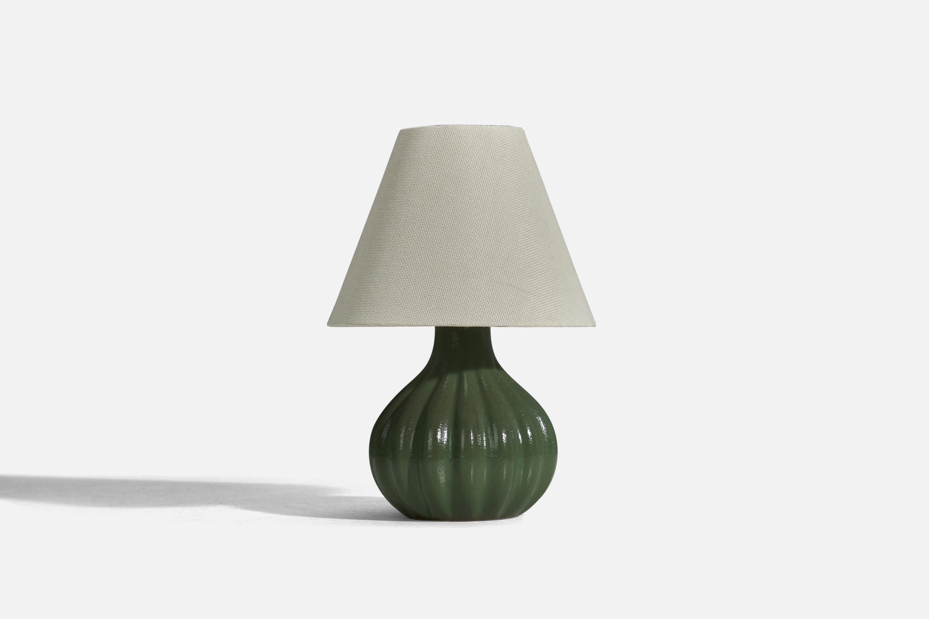 A green glazed stoneware table lamp designed and produced by Ego Stengods, Sweden, 1960s.

Sold without Lampshade
Dimensions of lamp (inches) : 8.25 x 5.56 x 5.56 (height x width x depth)
Dimensions of lampshade (inches) : 3.75 x 8 x 6.25 (top