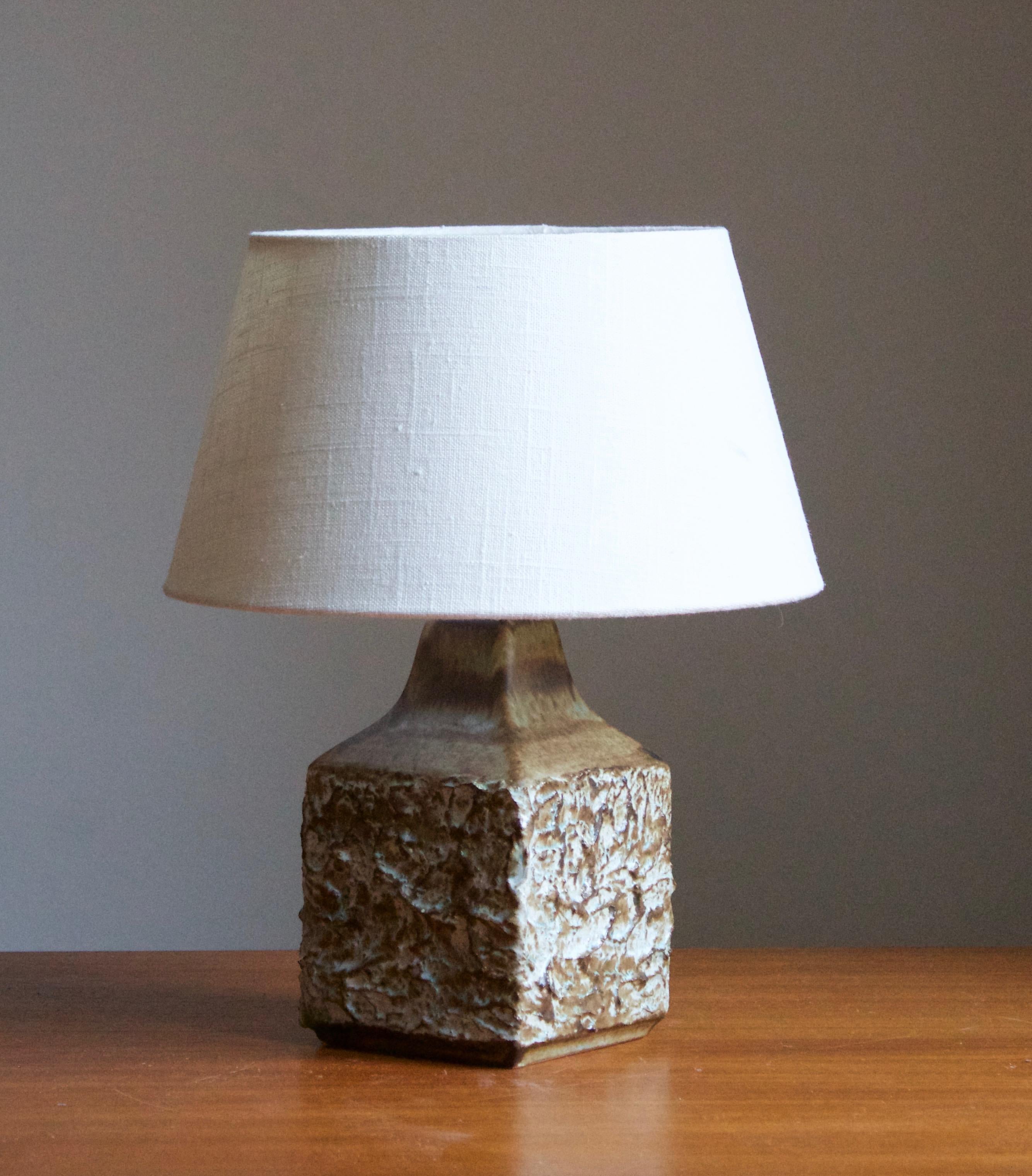 A stoneware table lamp. Produced by Ego Stengods c. 1960s-1970s. Stamped.

Stated dimensions exclude lampshade. Height including socket. Sold without lampshade.

Glaze features a brown color.

Other ceramicists of the period include Axel Salto, Arne