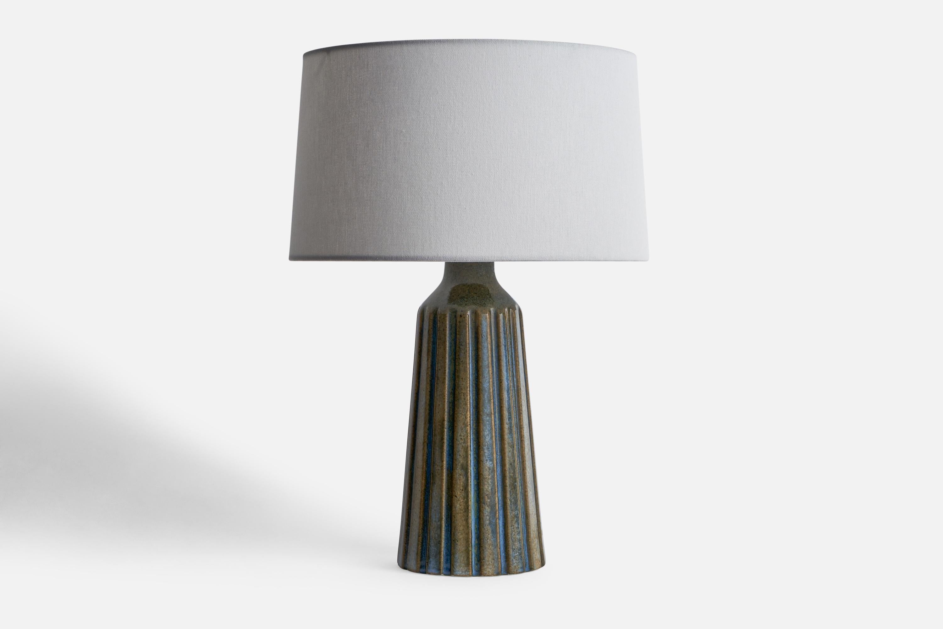 A blue and grey-glazed stoneware table lamp designed and produced by Ego Stengods, Sweden, 1960s.

Dimensions of Lamp (inches): 13.1” H x 5.05” Diameter
Dimensions of Shade (inches): 4.5” Top Diameter x 10” Bottom Diameter x 5.25” H
Dimensions of