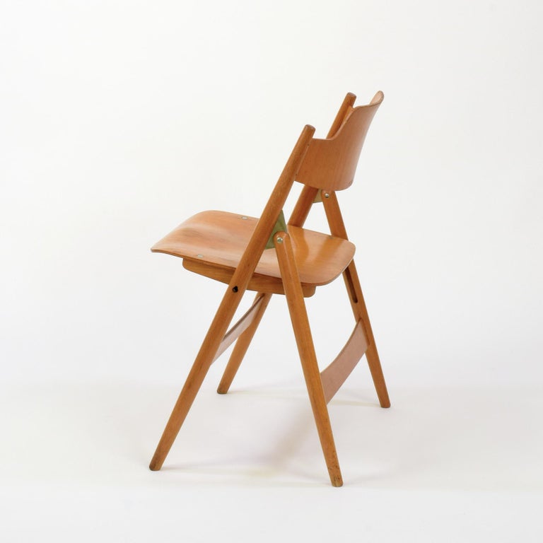 Egon Eiermann (designer), Germany
Wilde+Spieth (manufacturer), Germany
SE18 folding chair, designed 1952

Beech frame with laminated beech plywood seat and back. Clear lacquered finish.
Seat folds upwards when chair is folded.

Egon Eierman