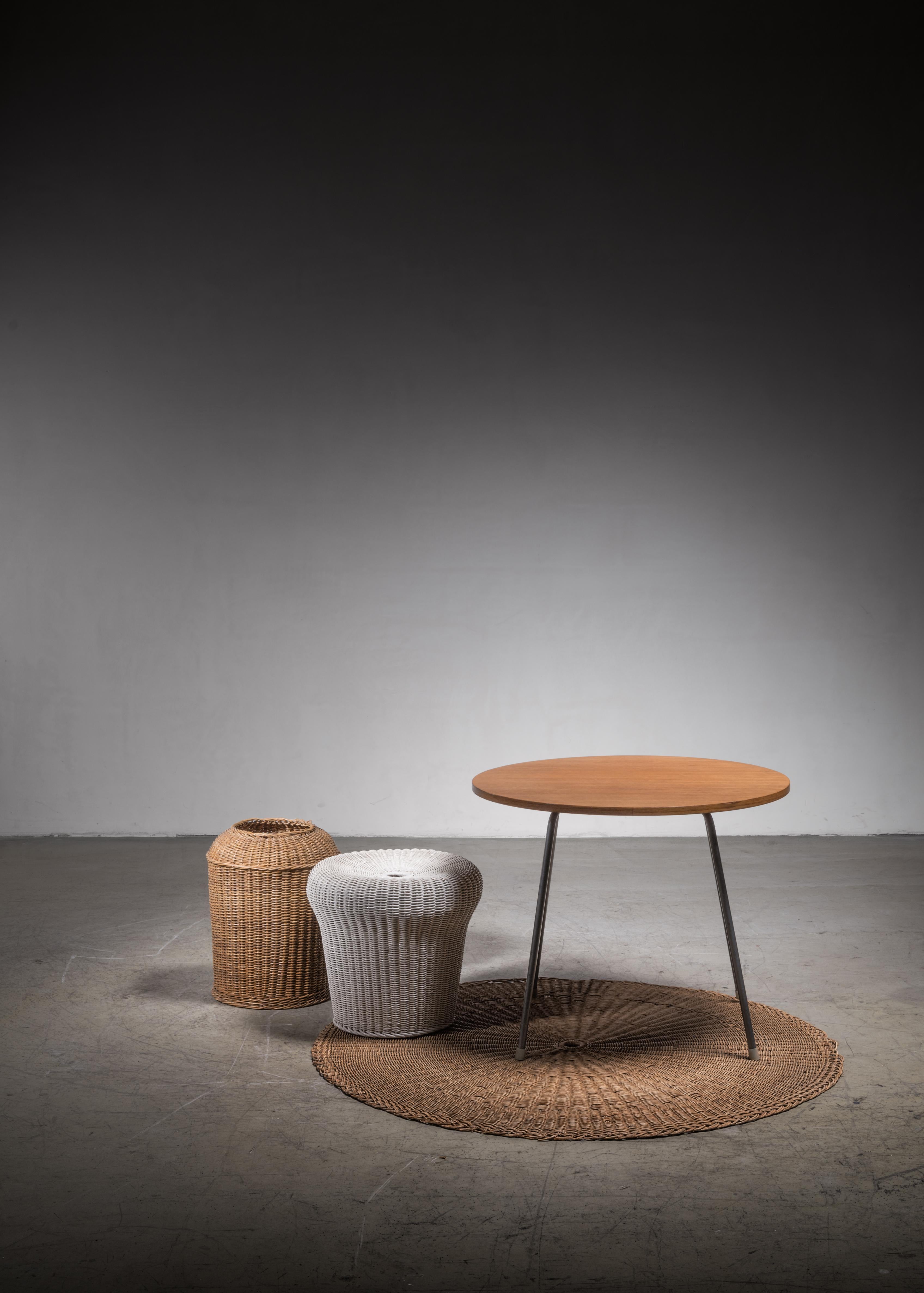A rare set of four pieces by German architect Egon Eiermann. It includes a 'SE 330' coffee table designed in 1952 for Wilde & Spieth and a wicker waste basket and floor mat designed in circa 1949 and produced by Friedrich Herr.

Please note that the