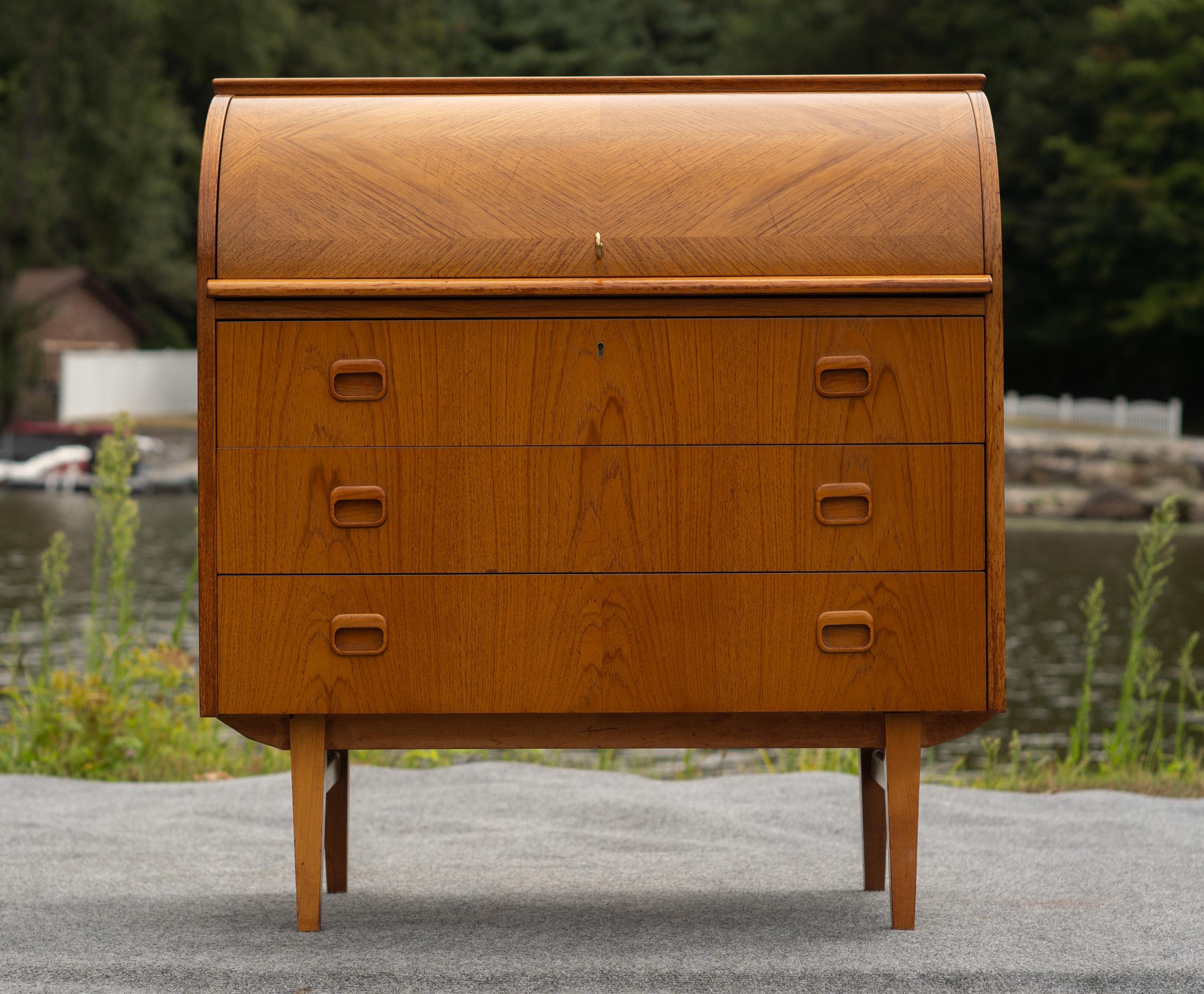 Designed in the 1960s by Egon Ostergaard, this desk was made by SMI, a somewhat nebulous figure in MCM production. We've had a number of SMI pieces, and the quality is always excellent. This desk is the same, with high-end teak construction, good