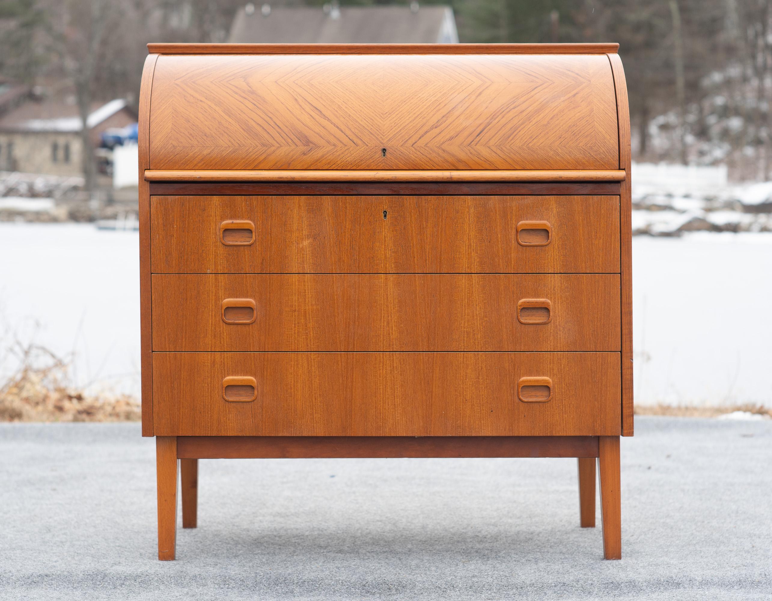 Designed in the 1960s by Egon Ostergaard, this desk was made by SMI, a somewhat nebulous figure in MCM production. We've had a number of SMI pieces, and the quality is always excellent. This desk is the same, with high-end teak construction, good