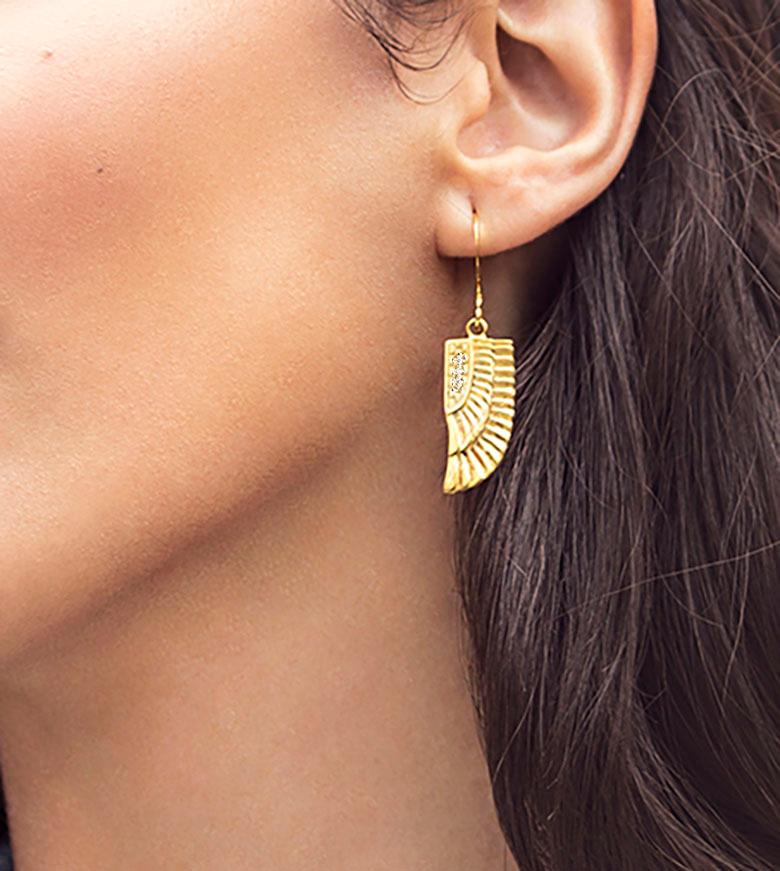 These polished diamond 18ct yellow gold wings dangle from your ear, inspired by the Goddess Isis who was worshiped in Ancient Egypt for being the ideal mother and wife alongside being the patroness of nature and magic. 

Carved by hand these
