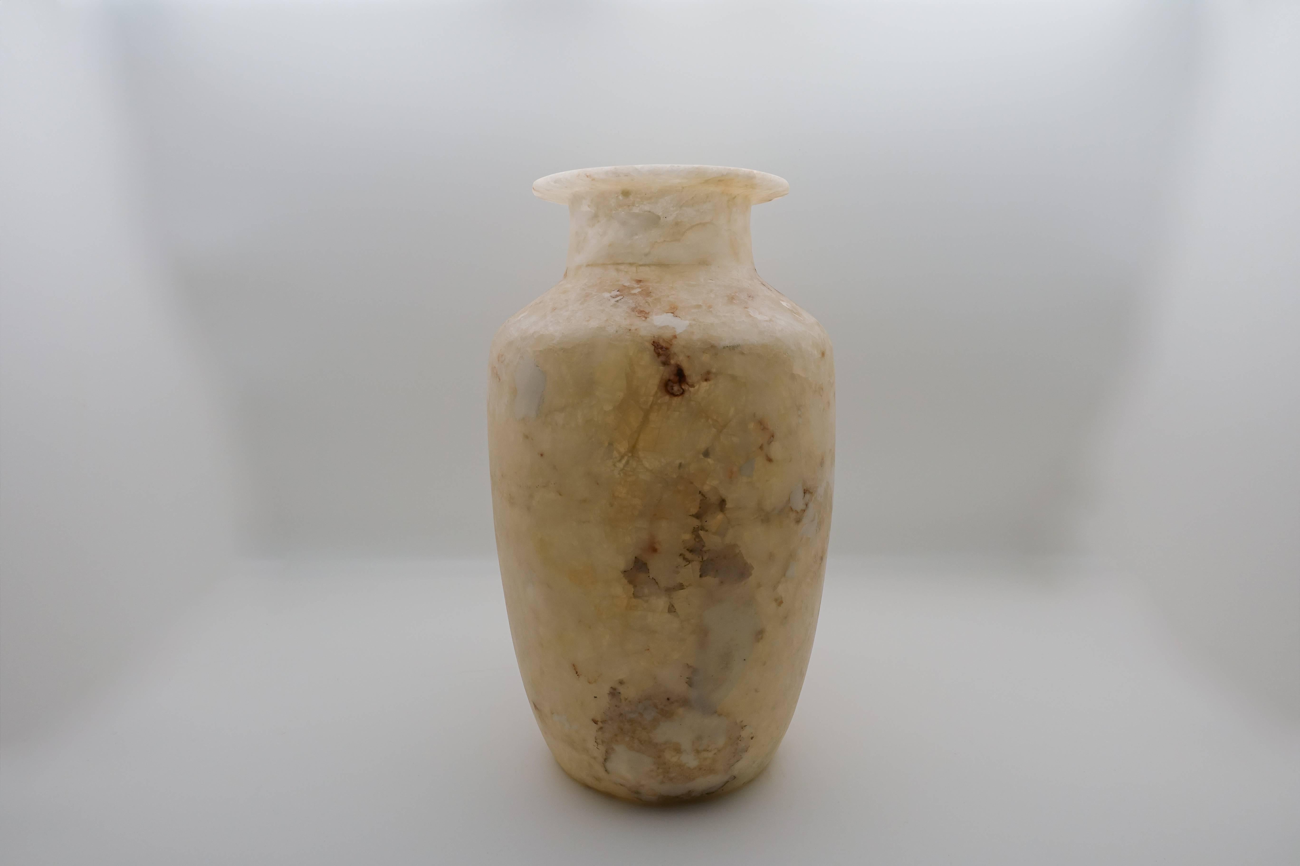 Beautifully hand-carved Egyptian alabaster vase. Techniques to carve this vase have been used by Egyptians for thousands of years. Alabaster's beauty comes from it's translucent nature that allows light to penetrate revealing it's warm natural