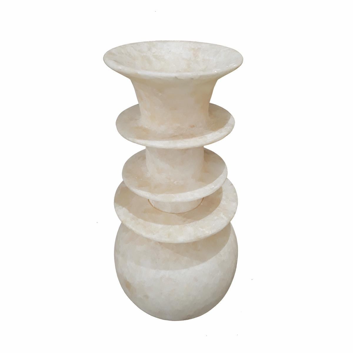 An alabaster vase, hand-crafted in Luxor, Egypt. Two pieces, with a bottom opening at the base. It allows the vase to be used as a lamp or screen for low-intensity lights (professional conversion recommended). 

The vase can be shipped in two pieces