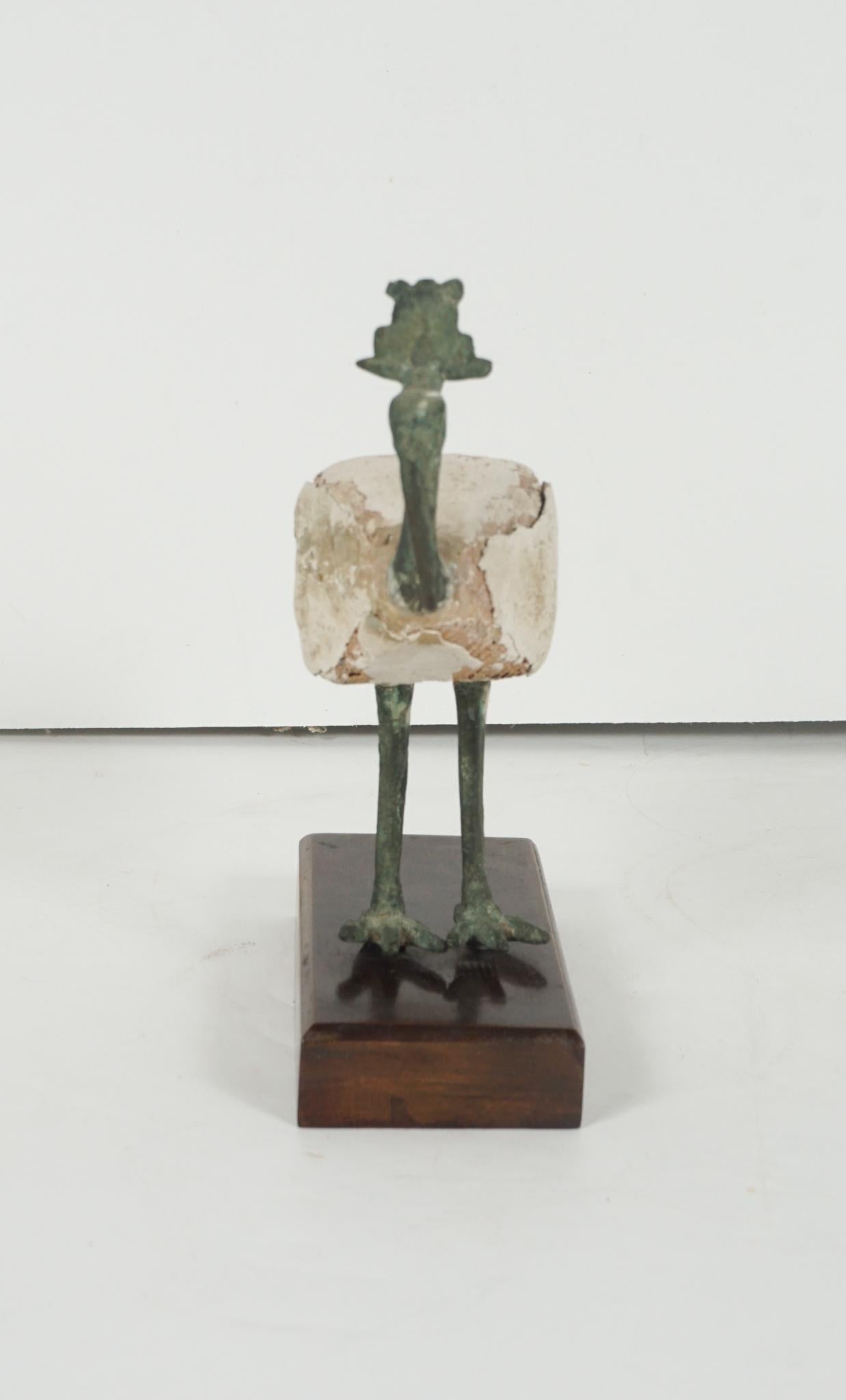 This figure composed of wood covered in gesso and mounted with cast bronze tail, head and legs has been set on a later wood base. The head and tail are finely detailed and engraved. Purchased in the Middle East in 1969 and then brought to this