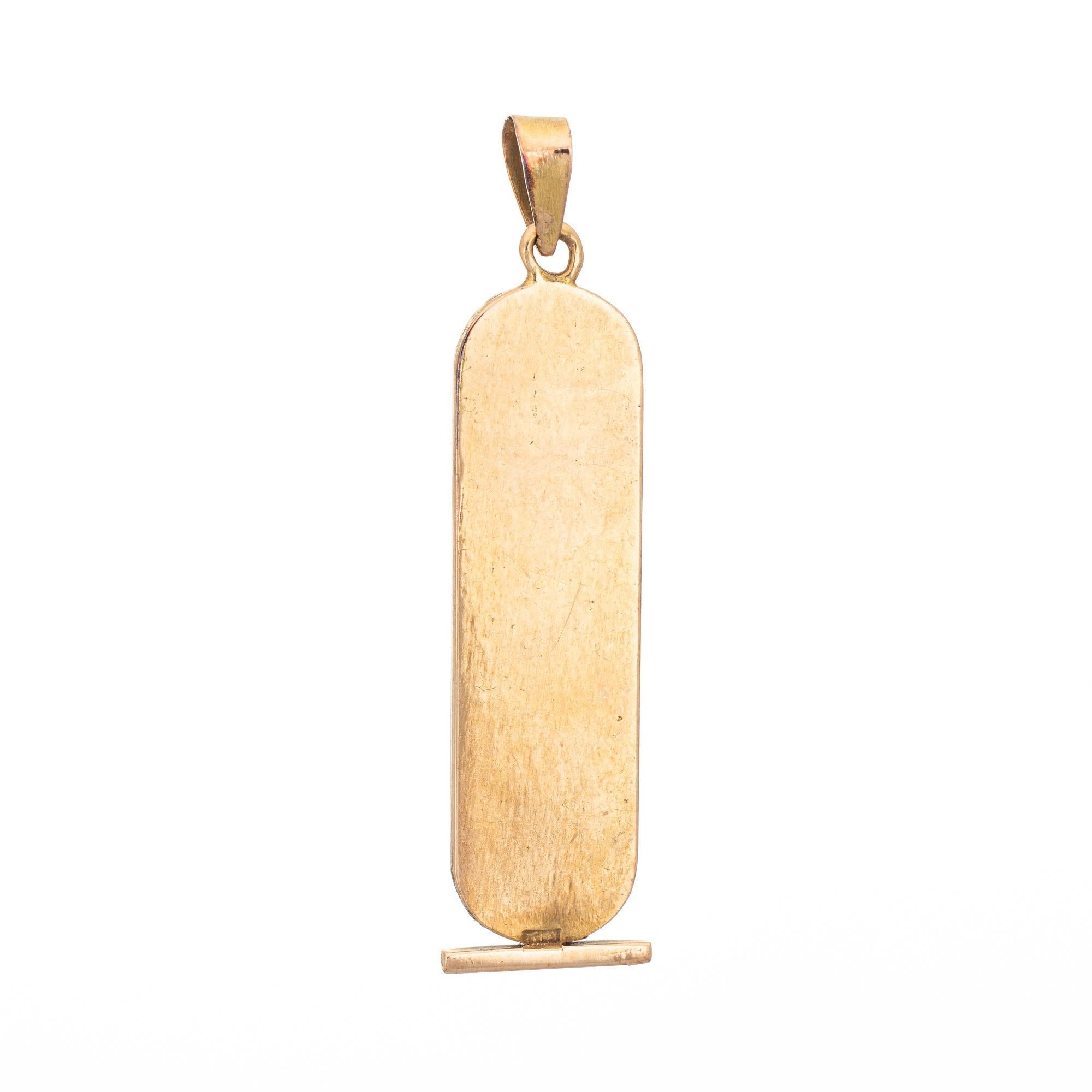 Finely detailed vintage Egyptian Cartouche Hieroglyphics pendant crafted in 18 karat yellow gold (circa 1970s to 1980s). 

The stylish pendant features three Hieroglyphics - Reed, Snake & Eagle that roughly represents the initials 