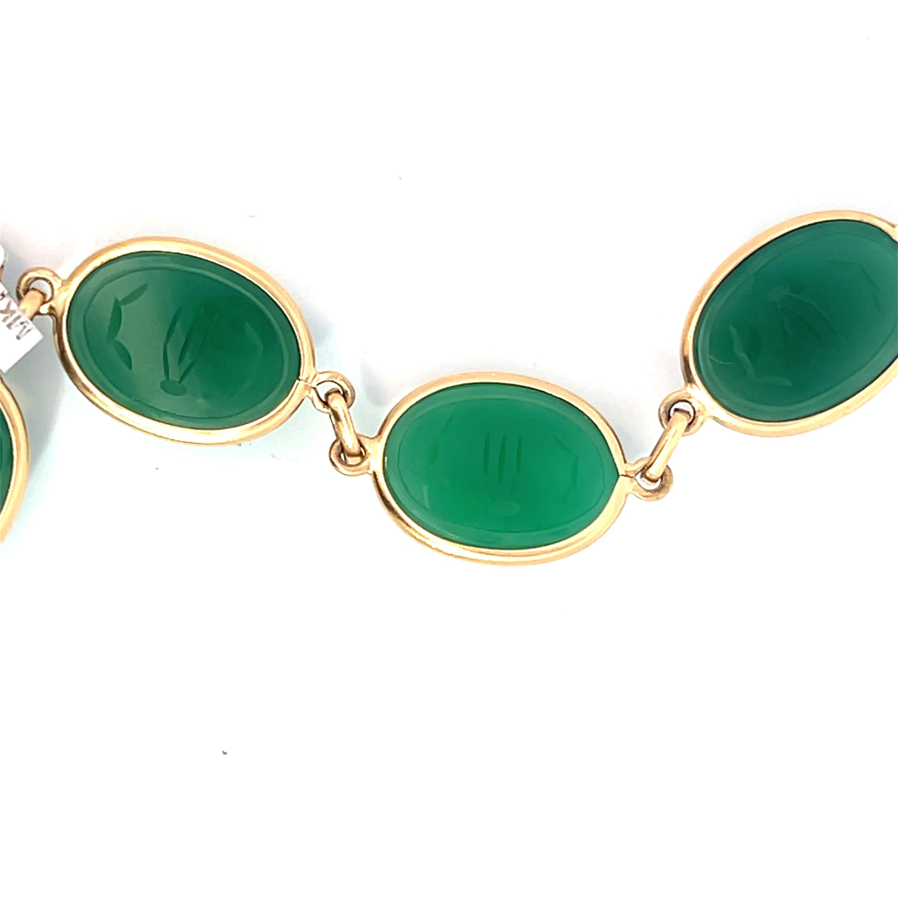 Scarab Chalcedony Yellow Gold Egyptian Bracelet. This exquisite bracelet features a series of vibrant green Chalcedony gemstones, each encased in a 14k yellow gold delicate bezel setting. Each Chalcedony gemstone features a meticulous, detailed