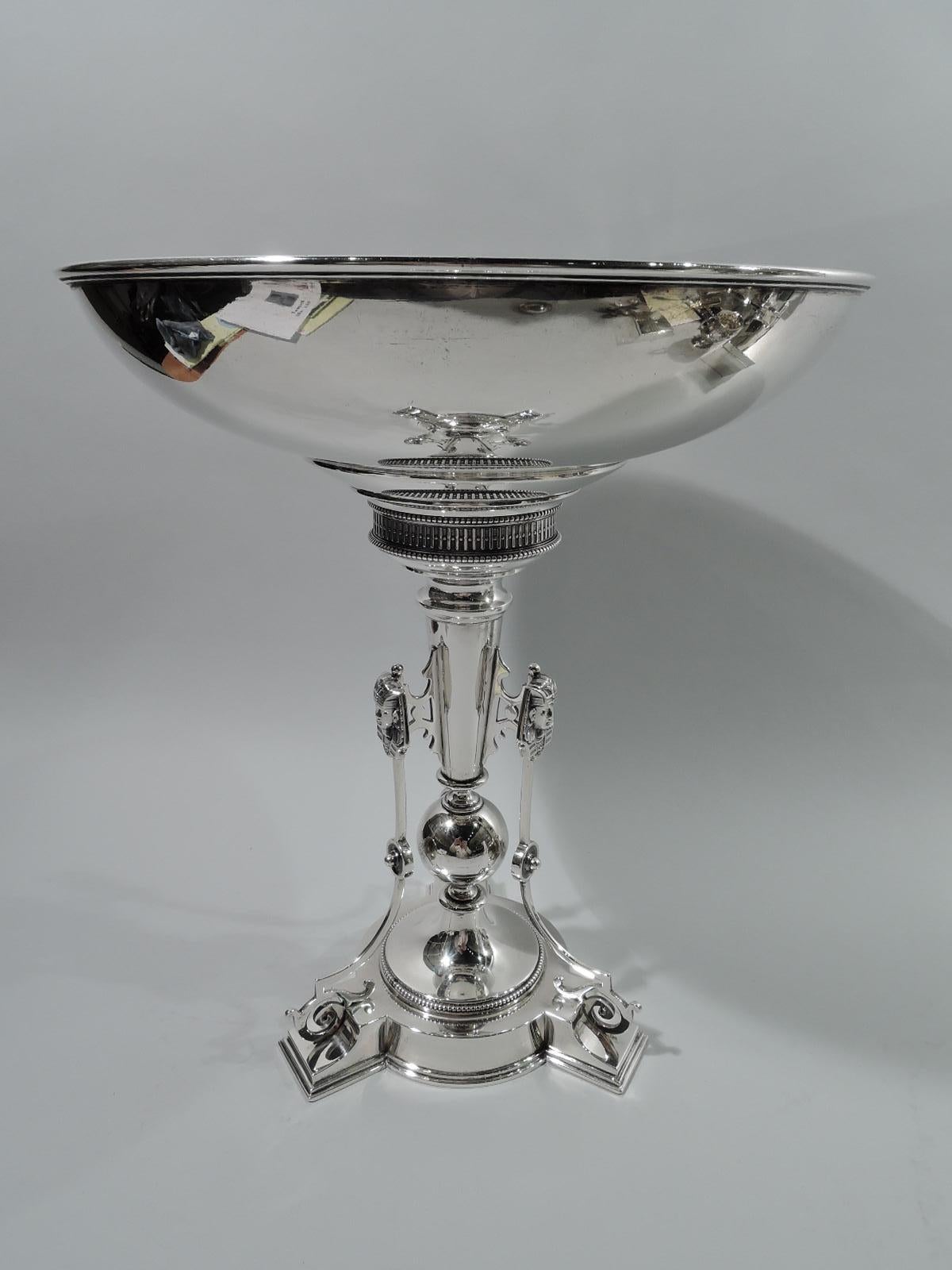 Egyptian Classical sterling silver compote. Made by John R. Wendt for Ball, Black & Co. in New York, ca 1870. Round and curved bowl on tapering columnar shaft on large ball knop mounted to raised and round tripod foot. Three scrolled brackets with