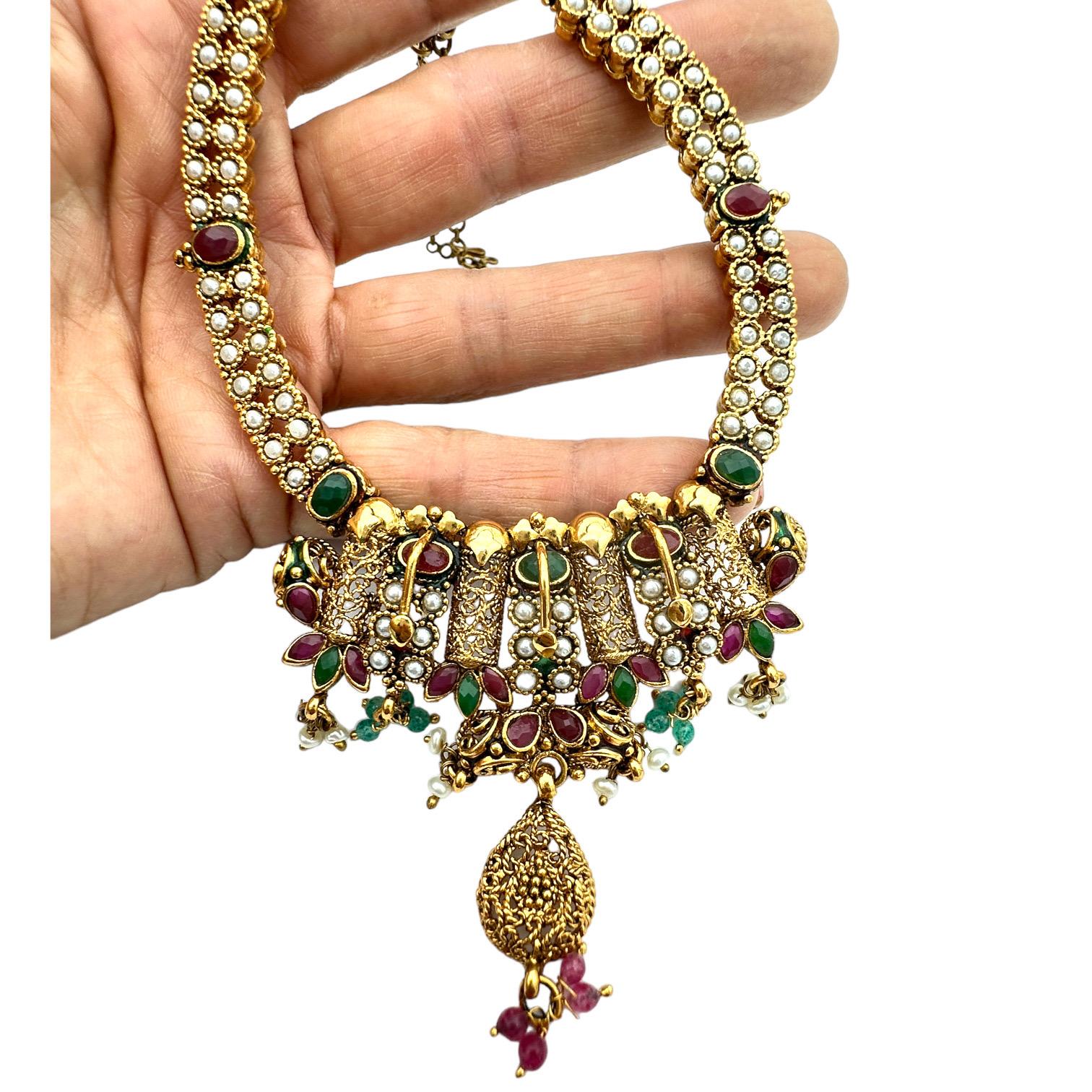  Add a touch of luxuriousness to your look with the Cleopatra necklace. This ornate choker features an exquisite handmade design, delicately crafted using color to create a truly unique piece. Wear it day or night for a glamorous finish every