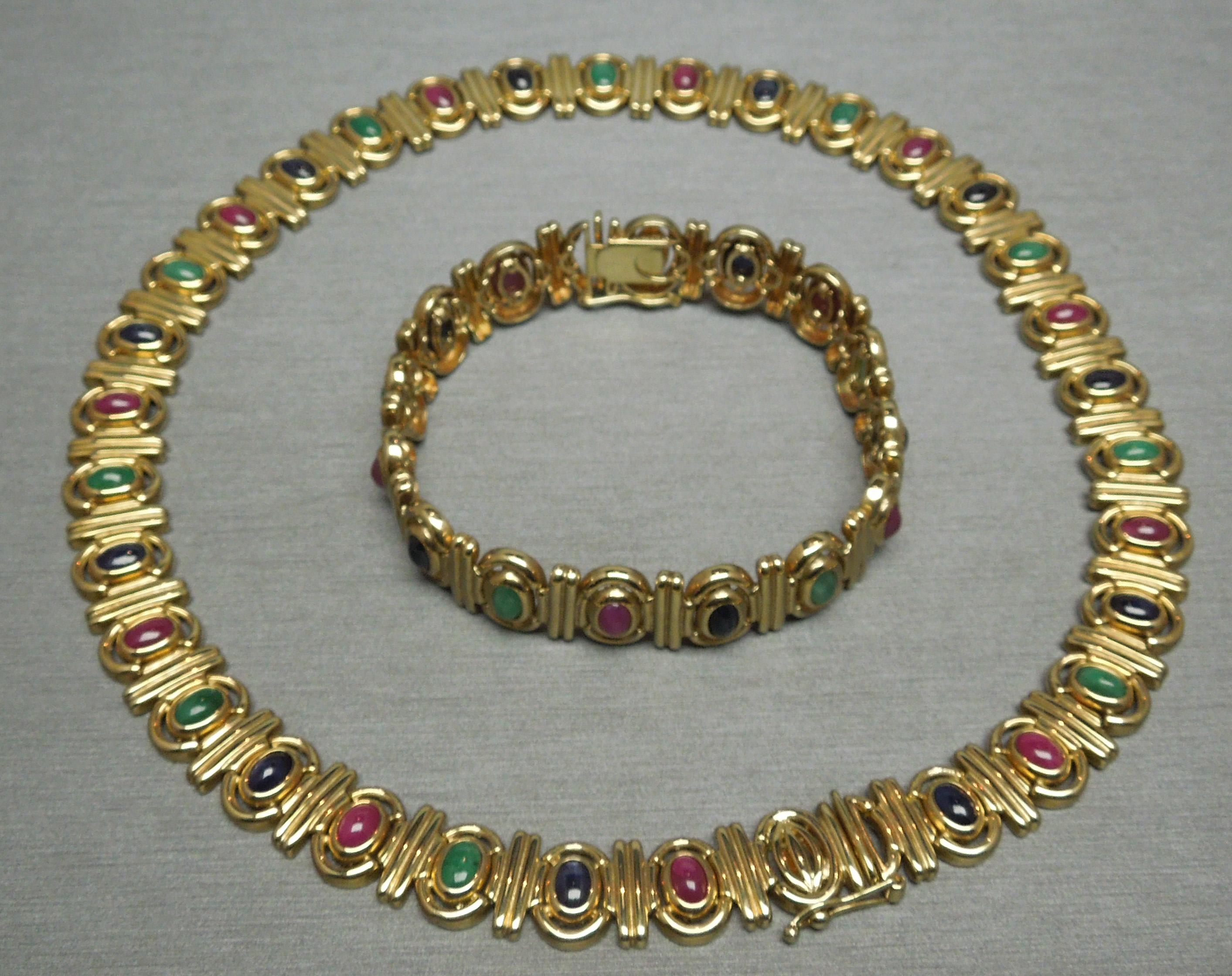 This Egyptian Cleopatra inspired Necklace & Bracelet set contains a total of 19 carats of Oval Cabochon cut Precious Gemstones, consisting of Rubies, Emeralds & Sapphires each securely Bezel set. Constructed completely of 14KT Yellow Gold [European]