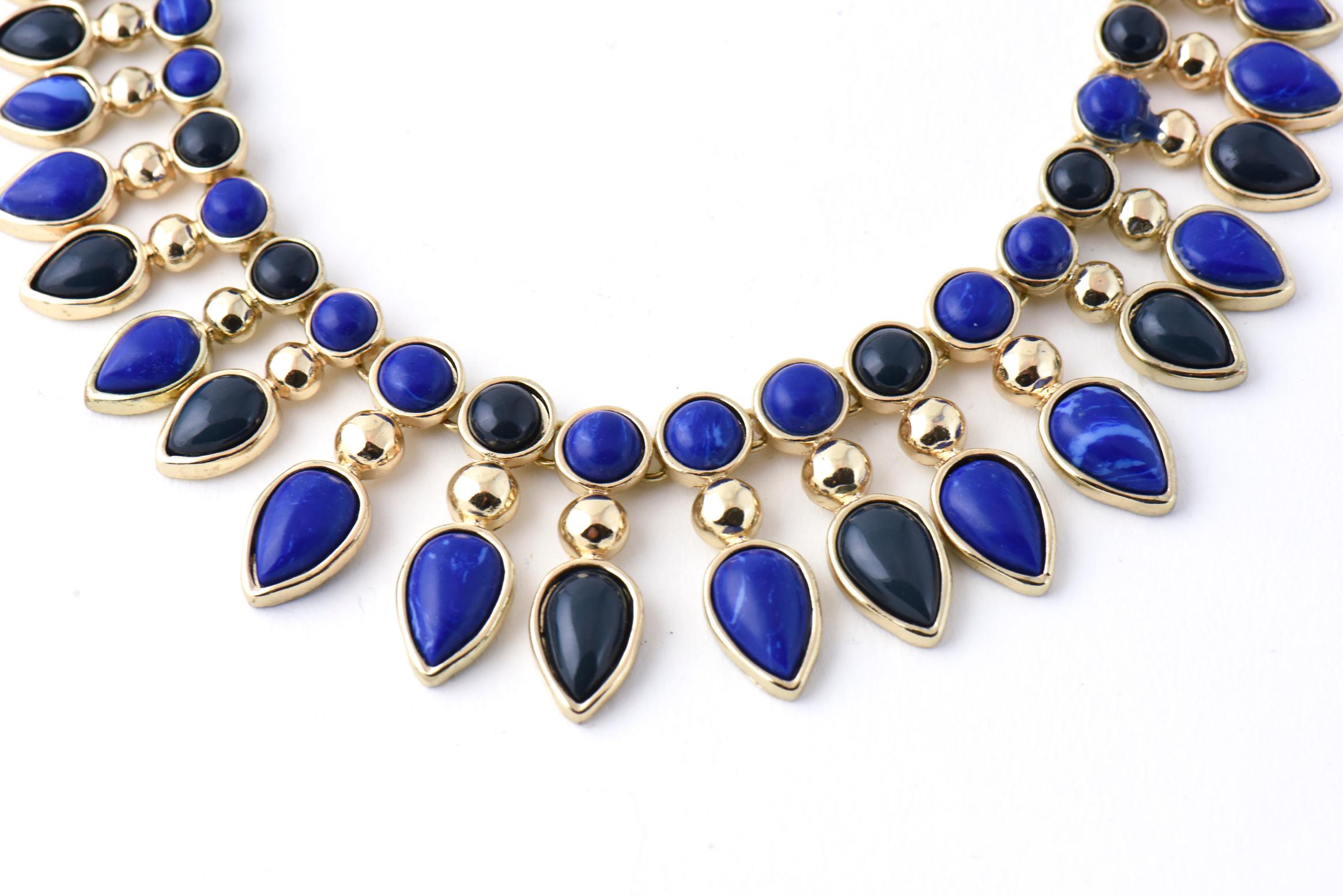 Stunning Cleopatra style necklace featuring costume blue and green resin pieces that  represent the jade and lapis lazuli often used in Egyptian jewelry.  The backside is as pretty as the front.  I believe you could wear it either way. The necklace