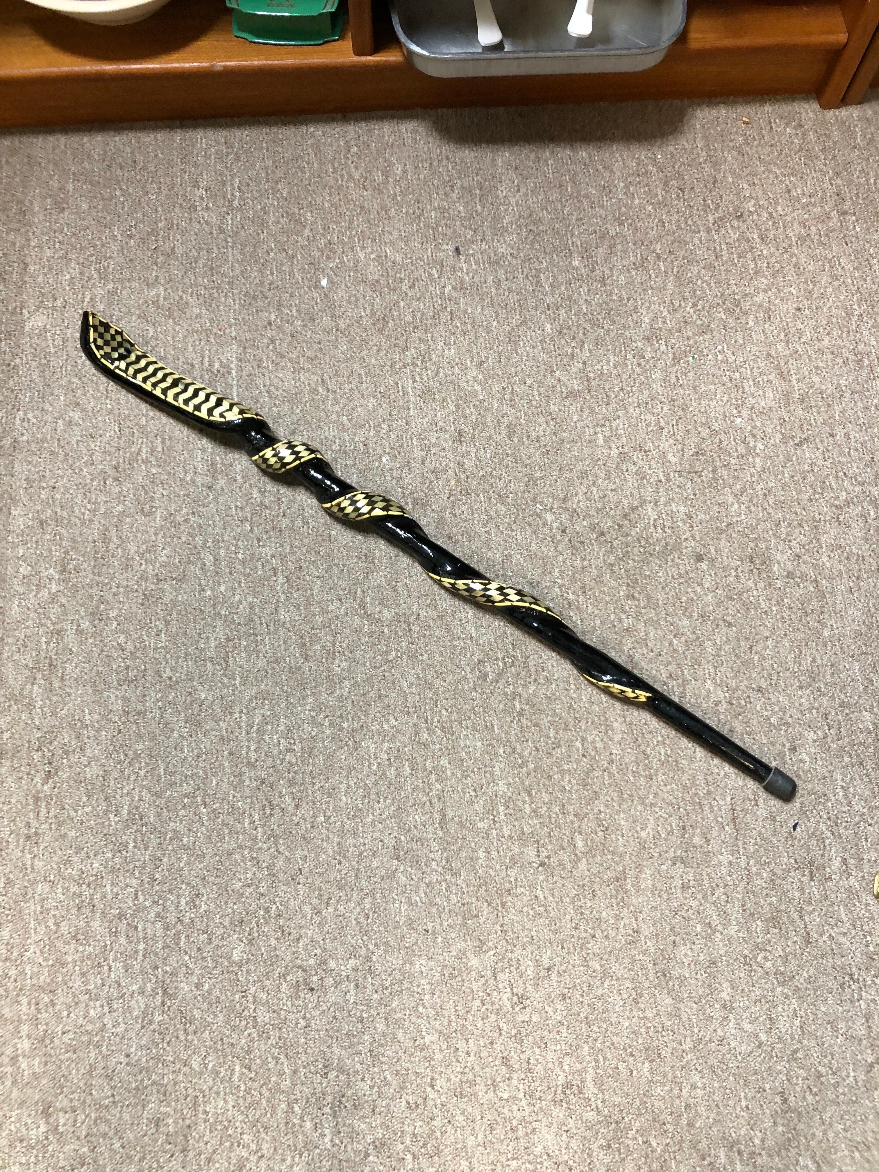 Egyptian Cobra Marquetry Inlayed Walking Stick with camel bone
inlayed details.
Black lacquered wood.
Size: 36.25