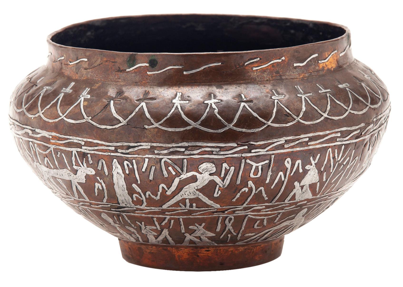 Egyptian copper & silver cache pot in an aged coppery finish that features attention to detail. The fine silver inlay work in the style of artisans from the old Egyptian market in Cairo.
The stylized calligraphy & Egyptian hieroglyphics are inset