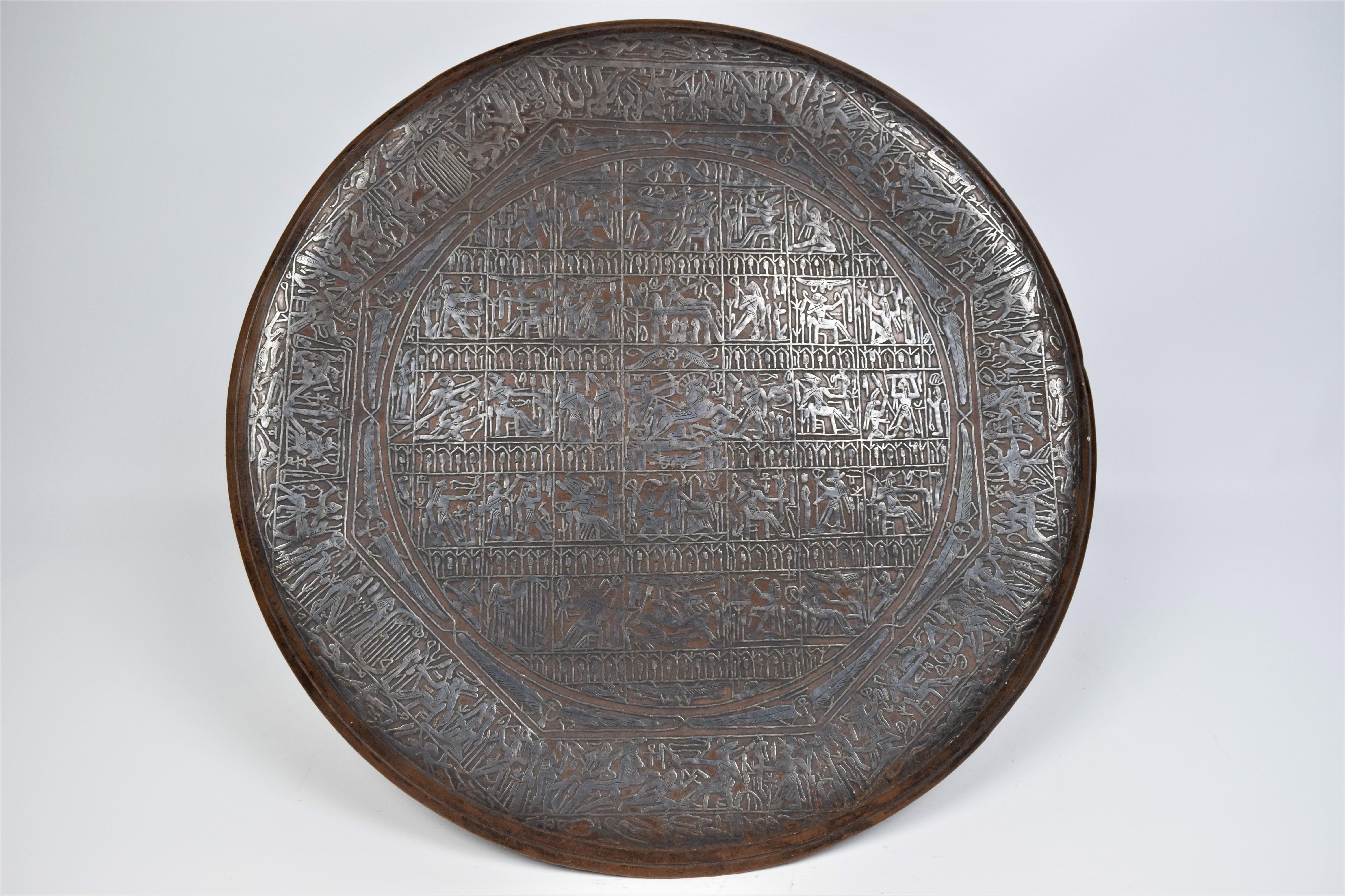 The large-scale copper charger plate with silver inlay is a truly awe-inspiring work of art. Its grand size and intricate design make it a captivating piece that commands attention and admiration.

The copper charger plate serves as the canvas for