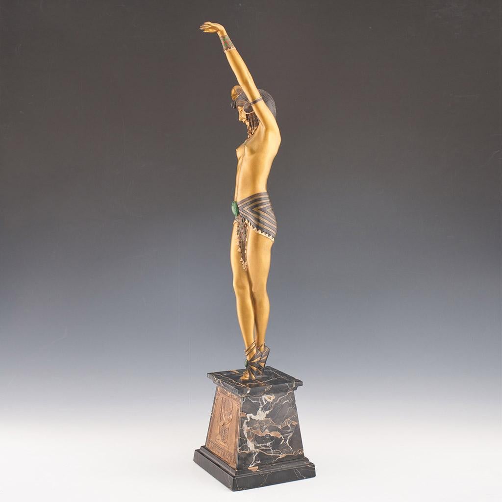 A cold painted enamel and gilt bronze sculpture of a dancer dressed in Egyptian style scantily clad costume with her arms outstretched. Set over a marble base with front plaque. Signed 'D H. Chiparus' to base. 

Dimensions: H 73cm W 15cm D