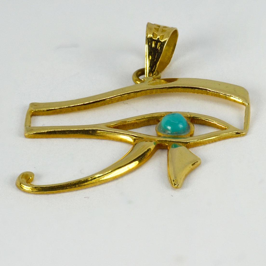 An 18 karat (18K) yellow gold charm pendant depicting the Egyptian Eye of Horus set with a turquoise cabochon to the eye. Stamped with Egyptian marks for 18 karat gold.

Dimensions: 2.5 x 2.7 x 0.25 cm (not including jump ring)
Weight: 2.83 grams
