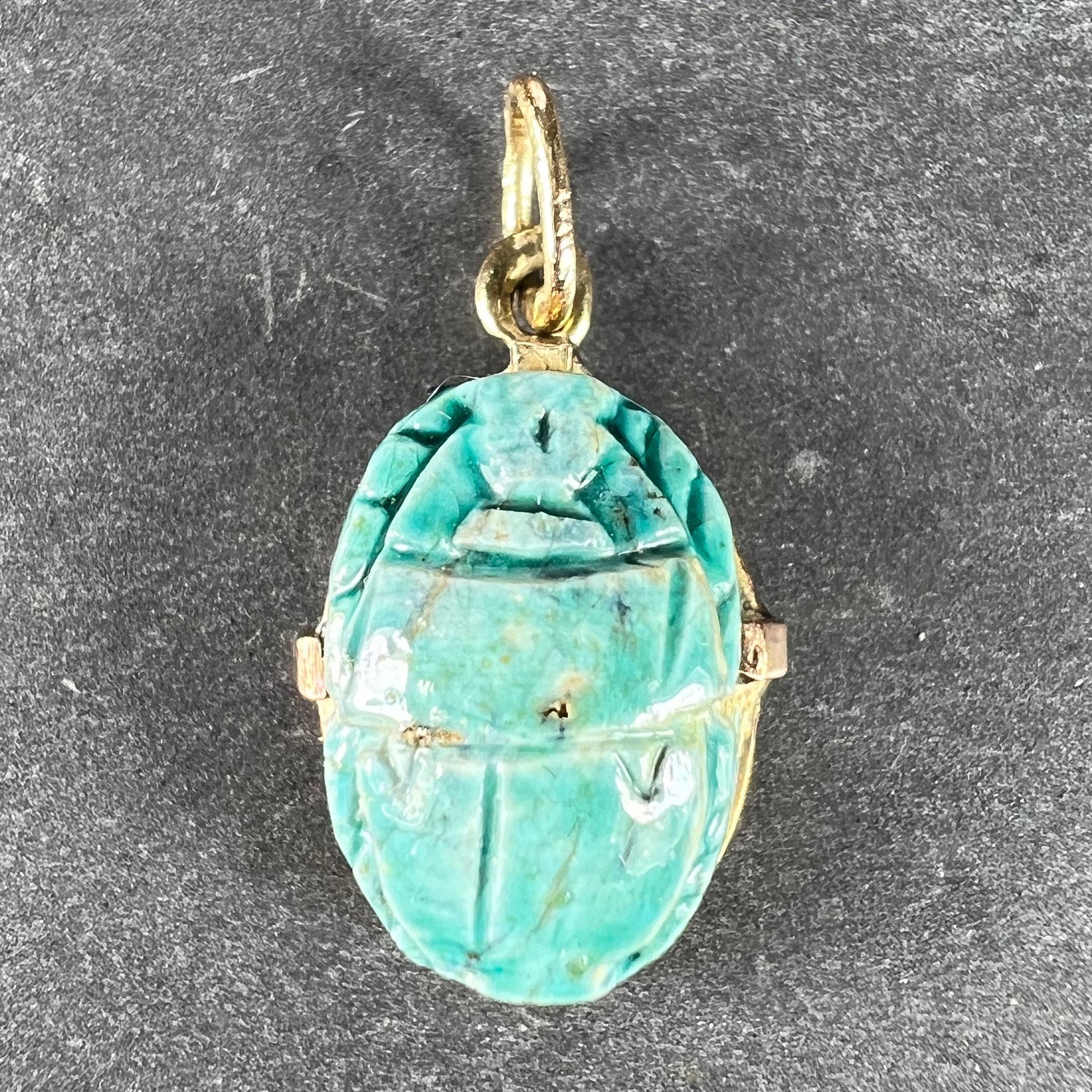 An 18 karat (18K) yellow gold charm pendant designed as the protective amulet of an Egyptian scarab in glazed blue faience on ceramic, engraved to both sides and encircled with gold wire. Unmarked but tested for 18 karat gold.
 
Dimensions: 1.8 x