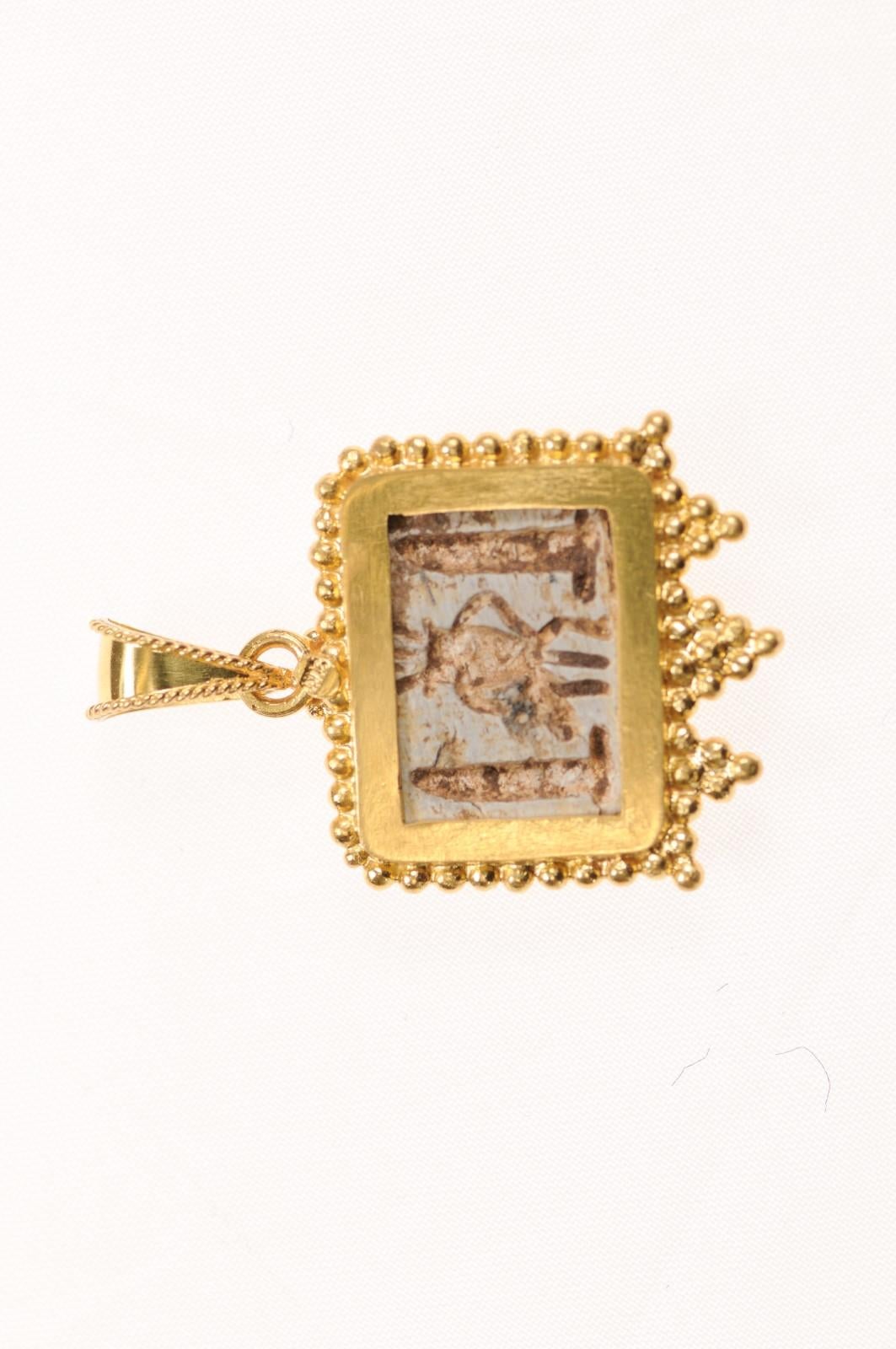 Pendentif en forme d'œil en faïence égyptienne, magnifiquement décoré d'or 21K. Ce fabuleux fragment est magnifiquement garni d'or 21 carats et ferait une excellente breloque de tous les jours ou une pièce d'apparat pour la bonne personne ! Il