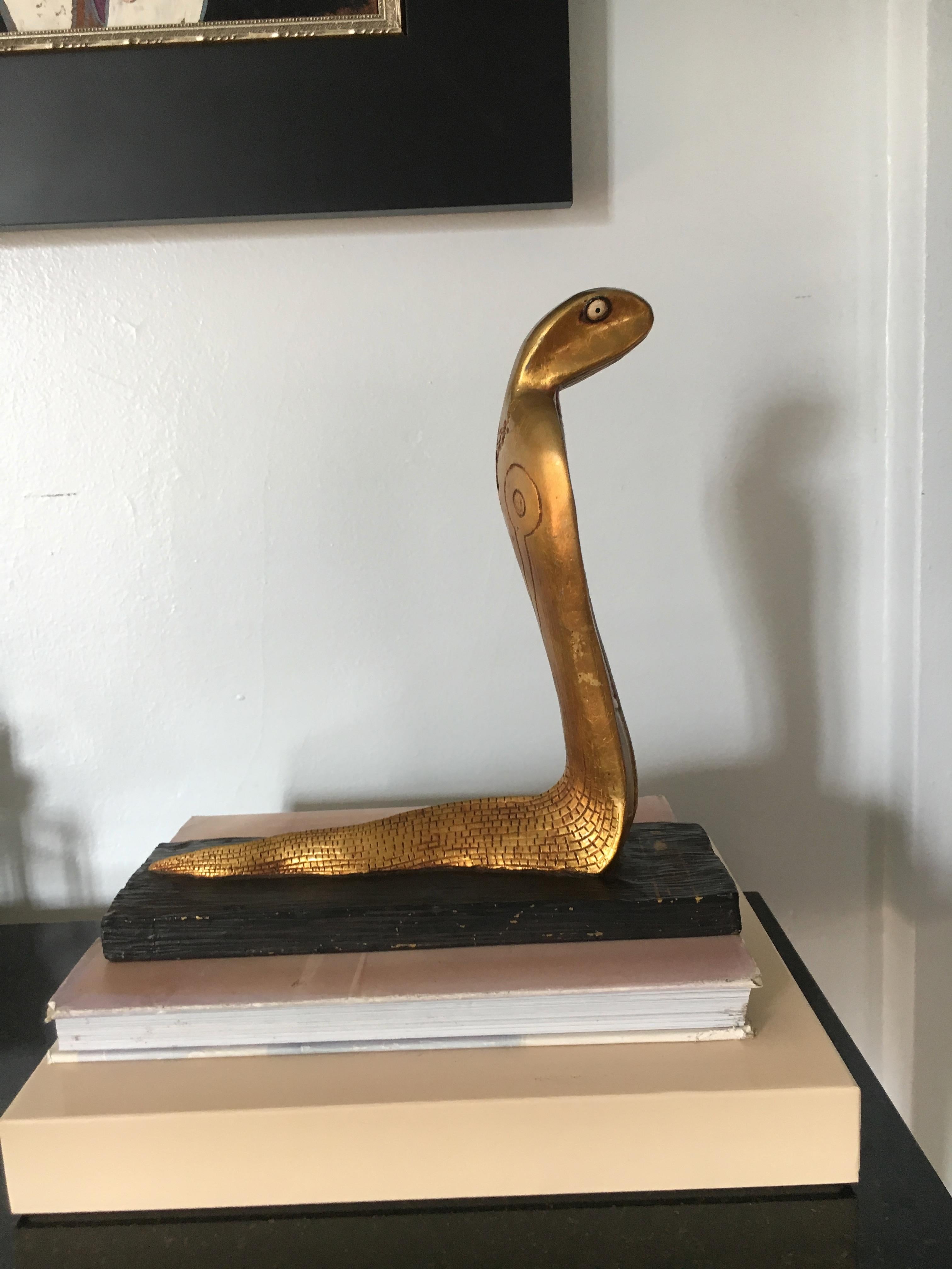 Gilt cobra sculpture bookend, a handsome decorate piece, the snake portion is likely plaster, or perhaps carved wood, with a striated wooden painted base, the piece has Egyptian hieroglyphics on the serpent and base.