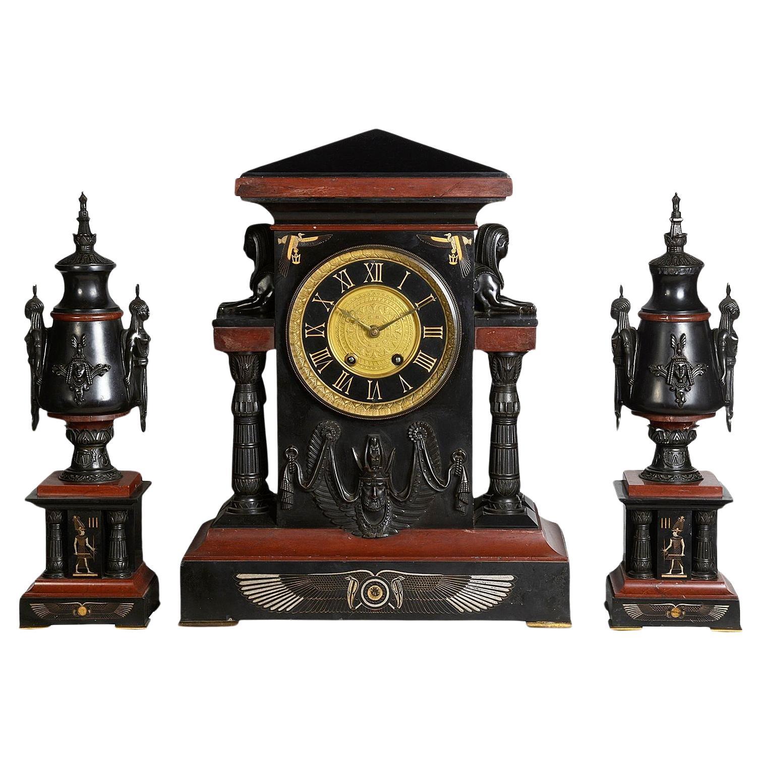 Egyptian influenced clock garniture, 19th Century.