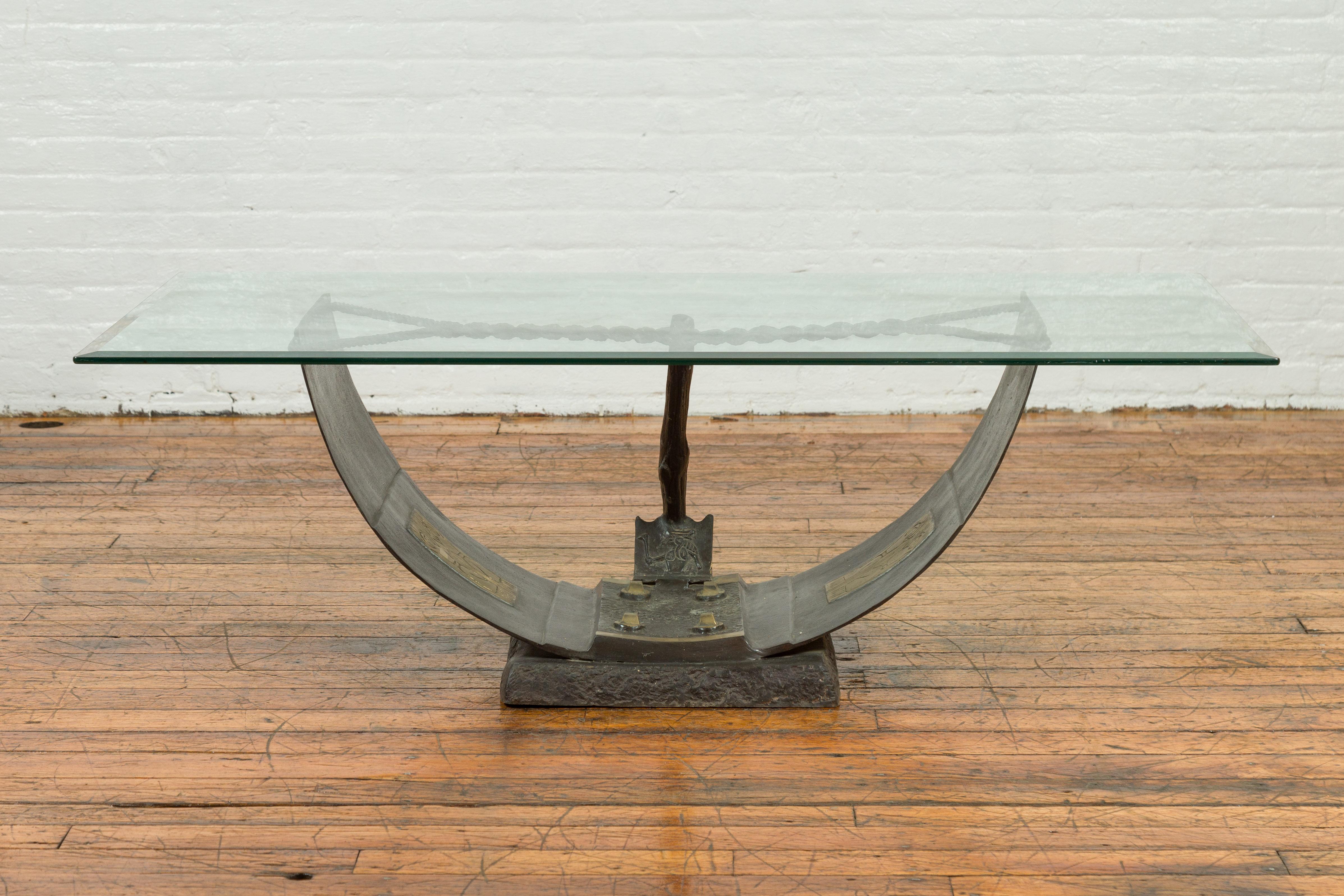 An Egyptian inspired contemporary nautical bronze coffee table base with Amun-Re motif and rope design, the glass top is not included but shown on the photos to evoke the possibilities. Created with the traditional technique of the lost-wax (à la