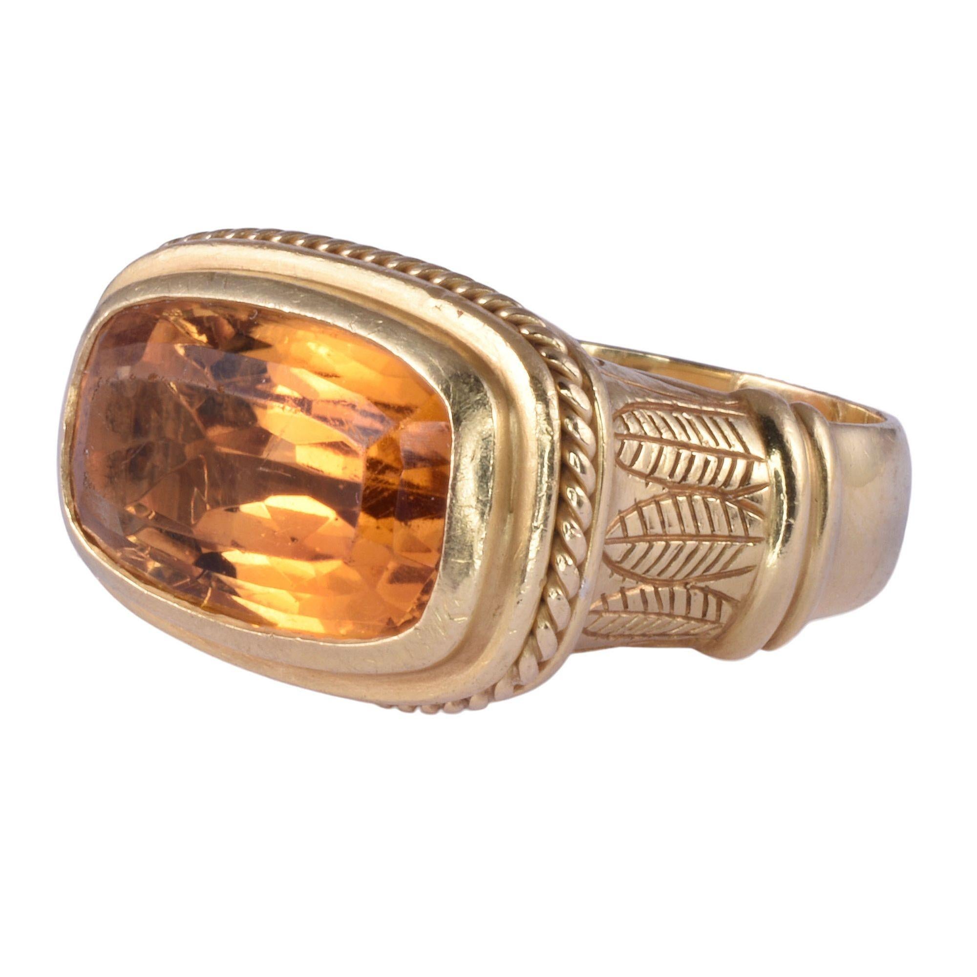 Estate Egyptian motif citrine 18K gold ring. This hand engraved Egyptian motif ring is crafted in 18 karat yellow gold and features a cushion cut citrine at 9.50 carats. This citrine ring is a size 8.25. [KIMH 615]
