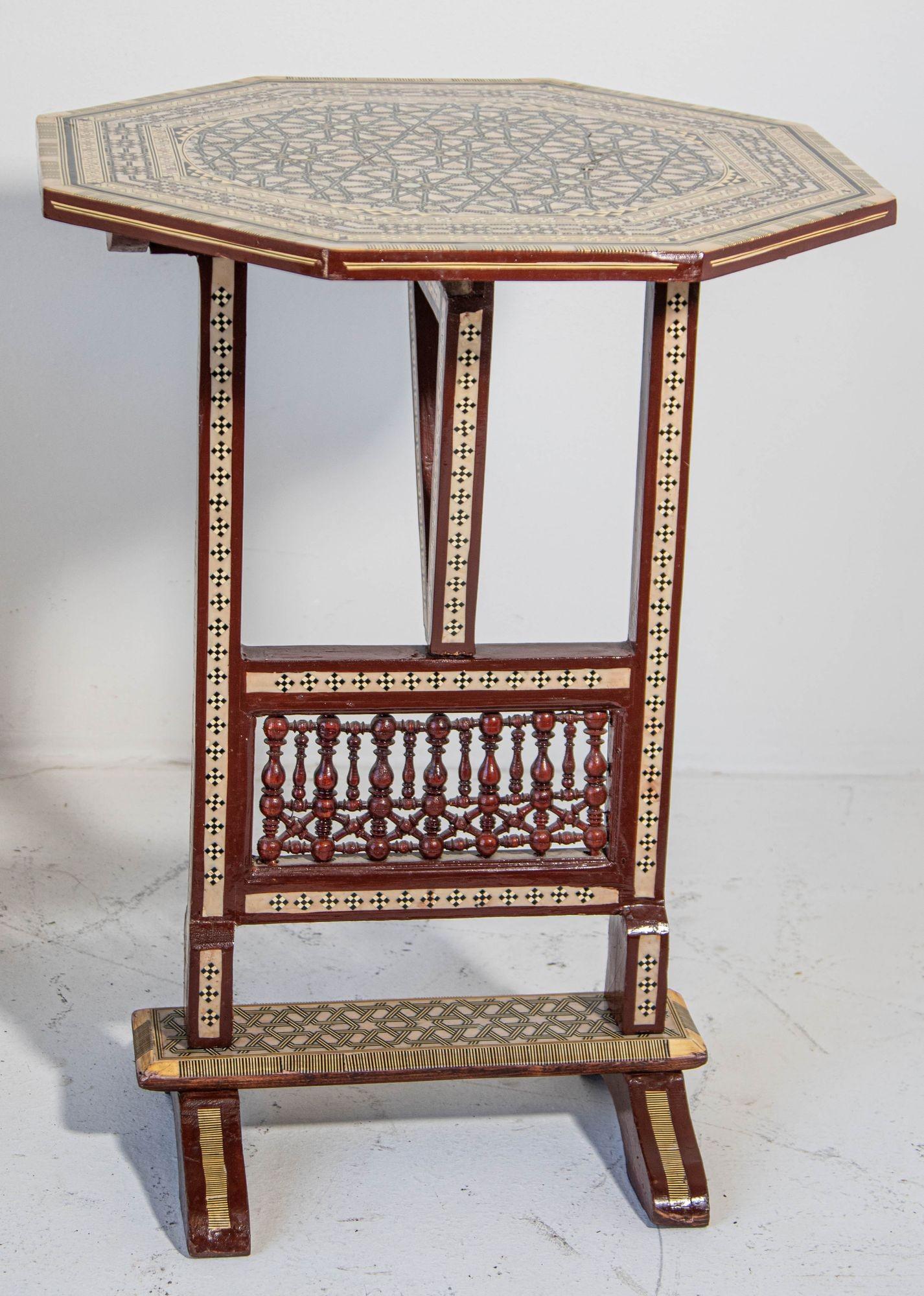 Vintage 1950s Egyptian Octagonal Side Table Egyptian Moorish Tilt-Top Inlaid Table.
Middle Eastern Egyptian octagonal side table with marquetry inlaid and mother-of-pearl.
Tilt-top drinks table with Moorish intricate geometric designs.
Octagonal