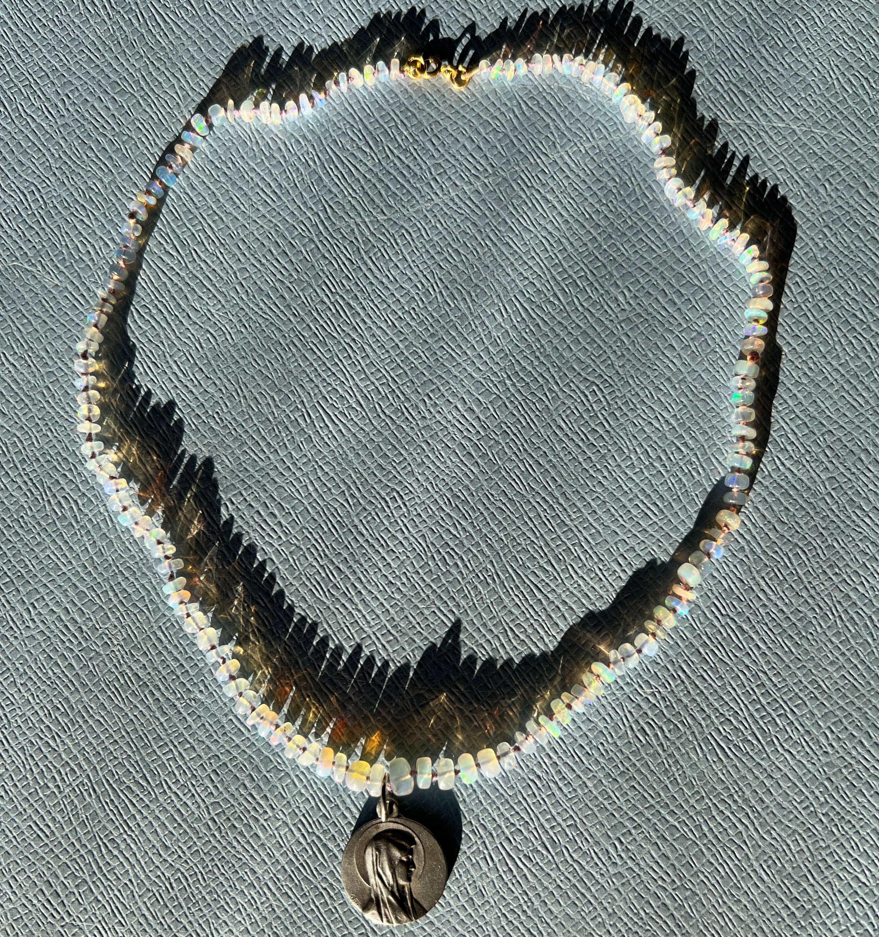 Medal Necklace Silver Virgin Mary EgyptianOpal Choker

Designer J Dauphin

Length: 16 inches

Opal, is considered a highly mystical and spiritual stone especially in contexts where gemstones are believed to influence or enhance spiritual and