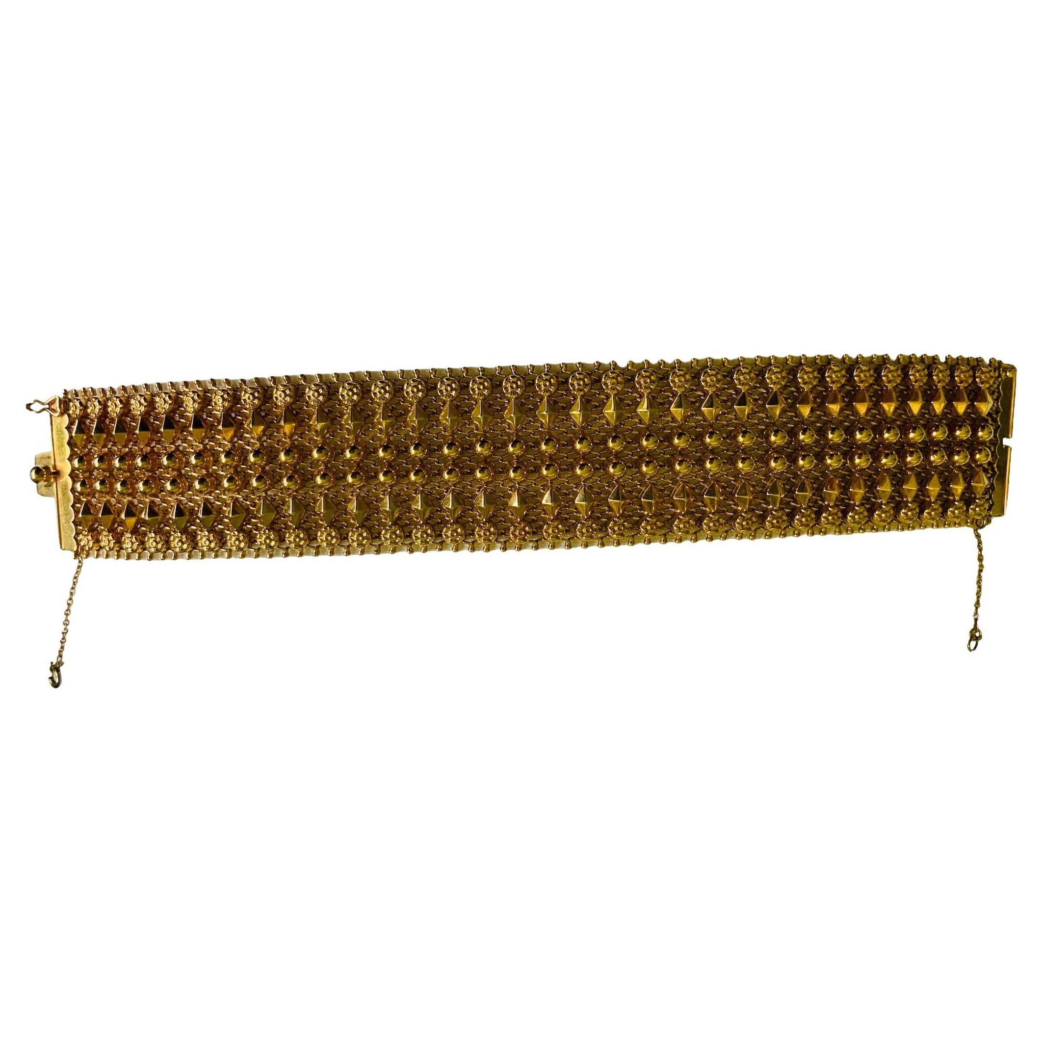 This is an Egyptian Revival Italian 18K Gold Mesh Bracelet. It depicts a yellow gold mesh wide bracelet adorned with thirty two columns made of gold flowers alternated with gold shaped diamonds and beads. The bracelet contains a hidden box clasp