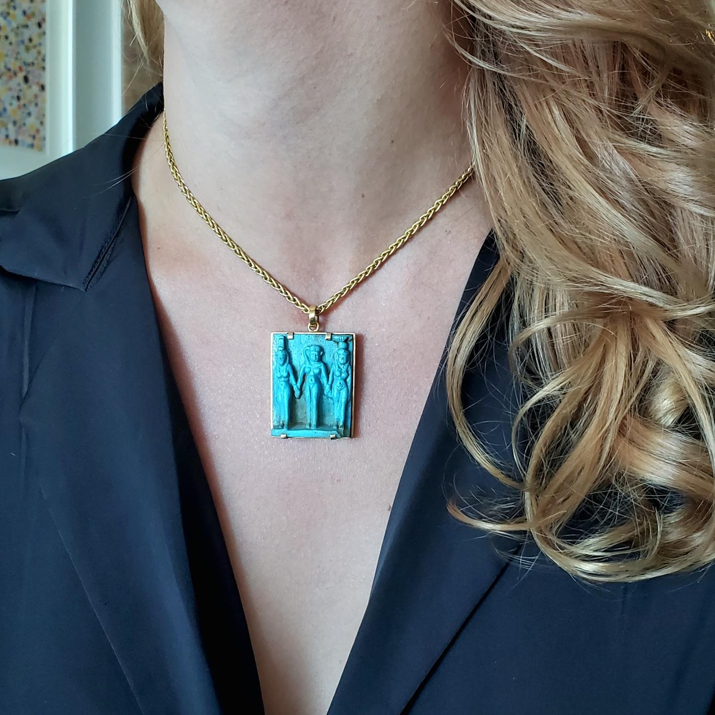 An Egyptian revival pendant with Egypt blue faience.

Beautiful amulet piece from the ancient Egypt, mounted in a squared frame crafted in solid yellow gold of 18 karats with high polished finish. Fitted on top with a movable link to wear in a cold