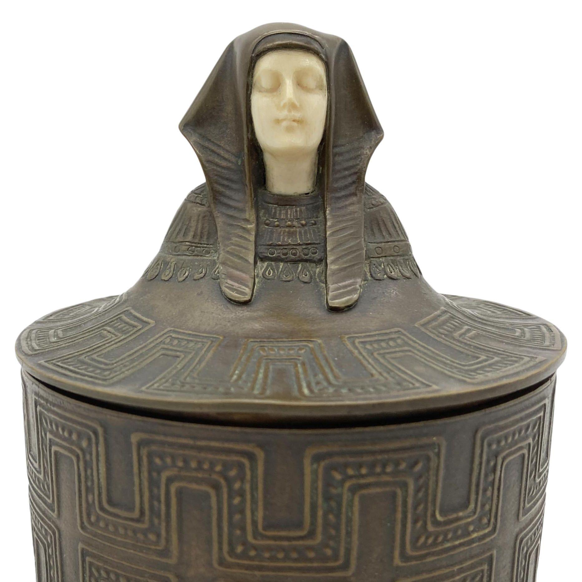 Early 20th Century Egyptian Revival Bronze Round Pharaoh Case W/ Carved Bone Face, Circa 1920 For Sale