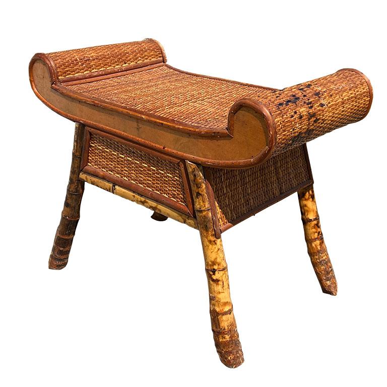 A rare Egyptian revival scrolled arm burnt bamboo bench or side table. This vintage piece will be a perfect addition to a bedroom or formal living used as a side table. The sprawled legs are made from burnt bamboo (or tortoise or tiger bamboo) and