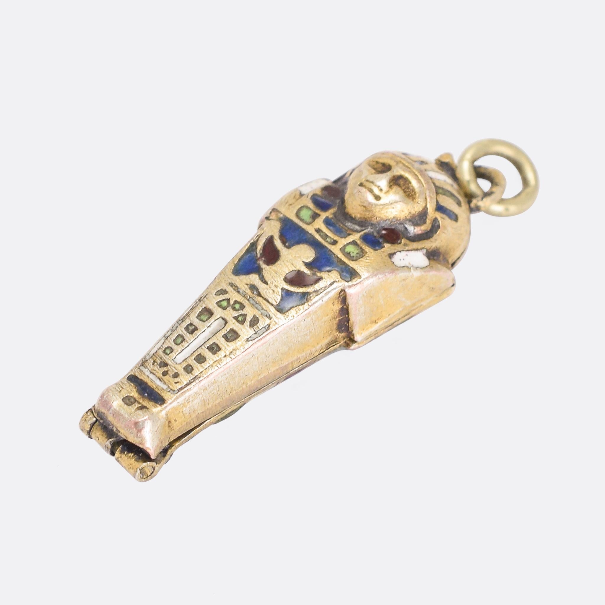 A cool 1920s Egyptian revival sarcophagus pendant that opens to reveal mummy inside. It's modelled in silver gilt, and finished in colourful enamel. Well detailed, and likely of Egyptian origin.

MEASUREMENTS 
3.2 x 1.1cm

WEIGHT 
4.3g

MARKS 
No