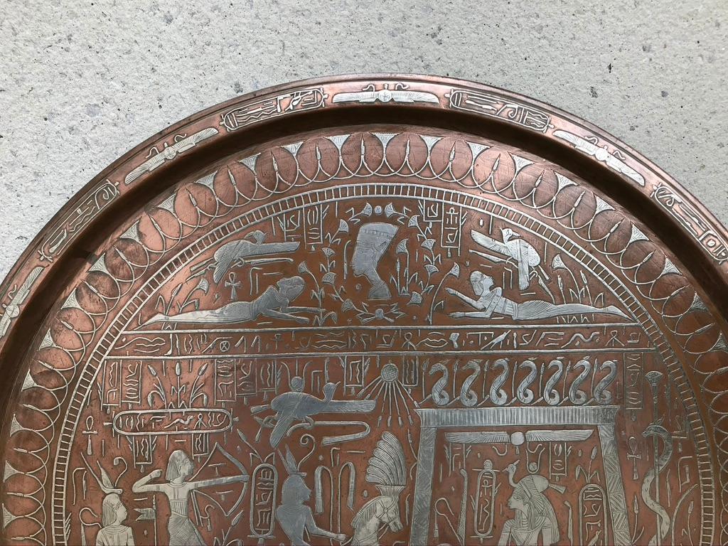 A very impressive large-scale copper charger with silver inlaid decoration. The surface is covered with finely detailed hieroglyphics, including the goddess Isis on her throne, a chariot and rider with bow and arrow, the three pyramids, the sphinx,
