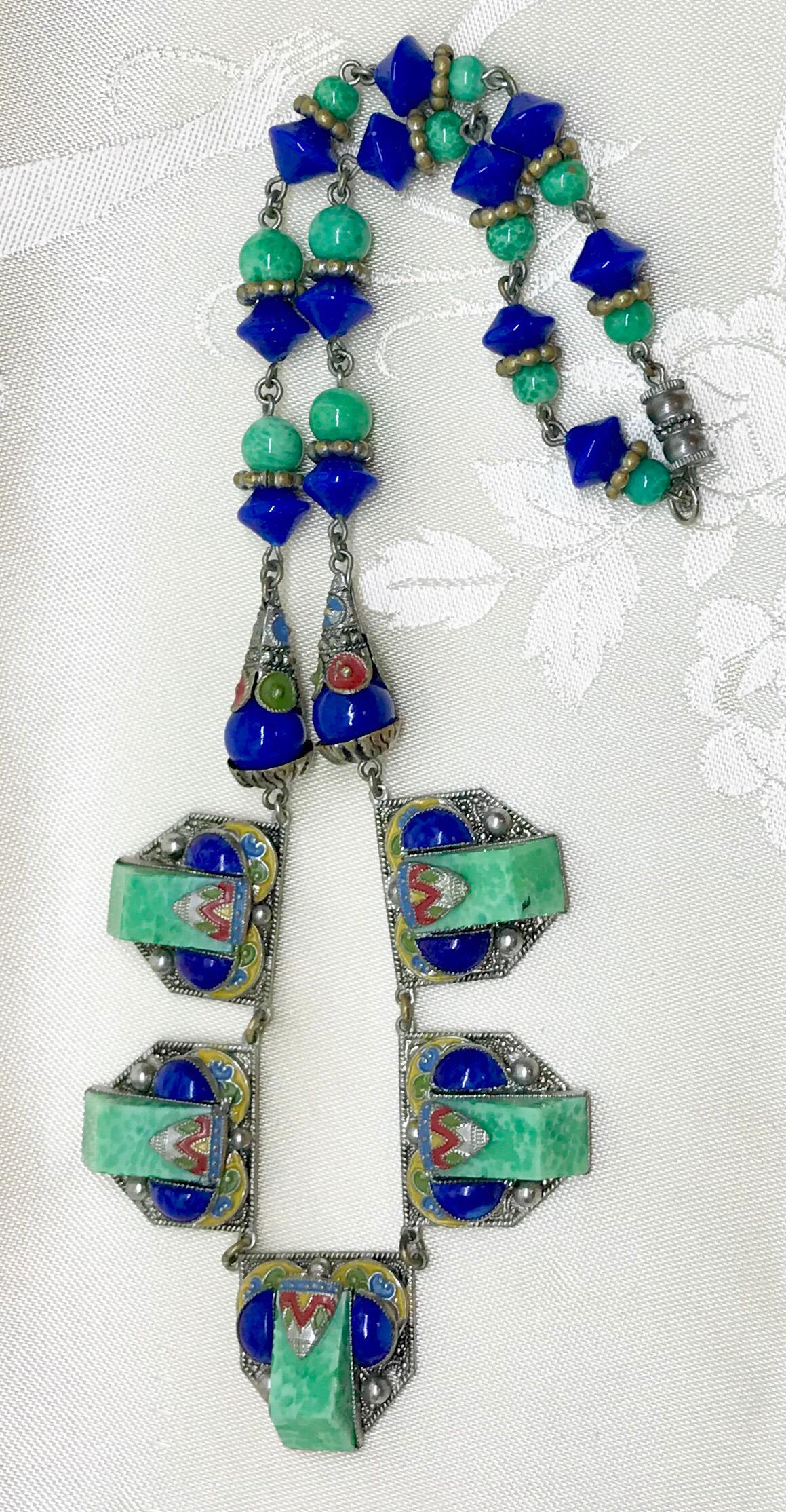 Circa 1920s to early 1930s Czechoslovakian Egyptian Revival Necklace with silver-plated brass plaques bezel set with green glass geometric stones, dark blue cabochons and embellished with enameling.  The remainder of the necklace is made up of green