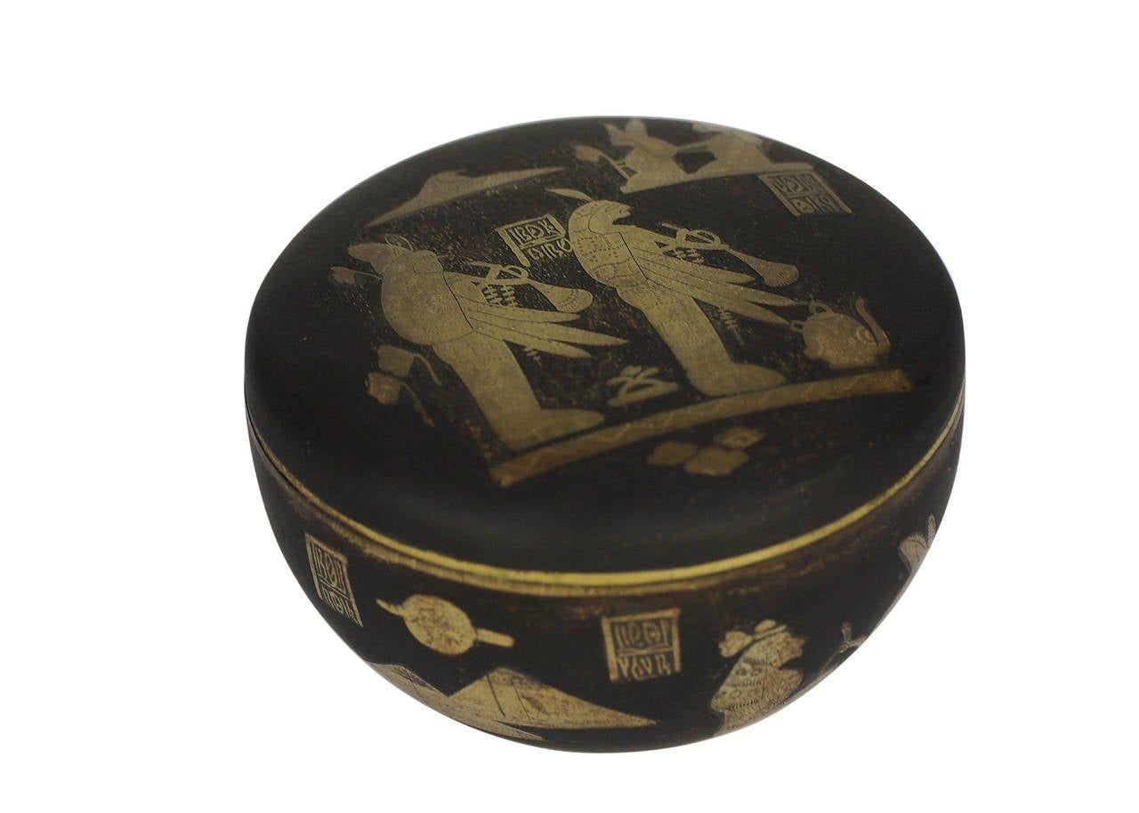 This Egyptian Revival Damascene decorative box features a gold plate finish with hand etched Egyptian hieroglyphics along the lid and sides, from circa 1920.