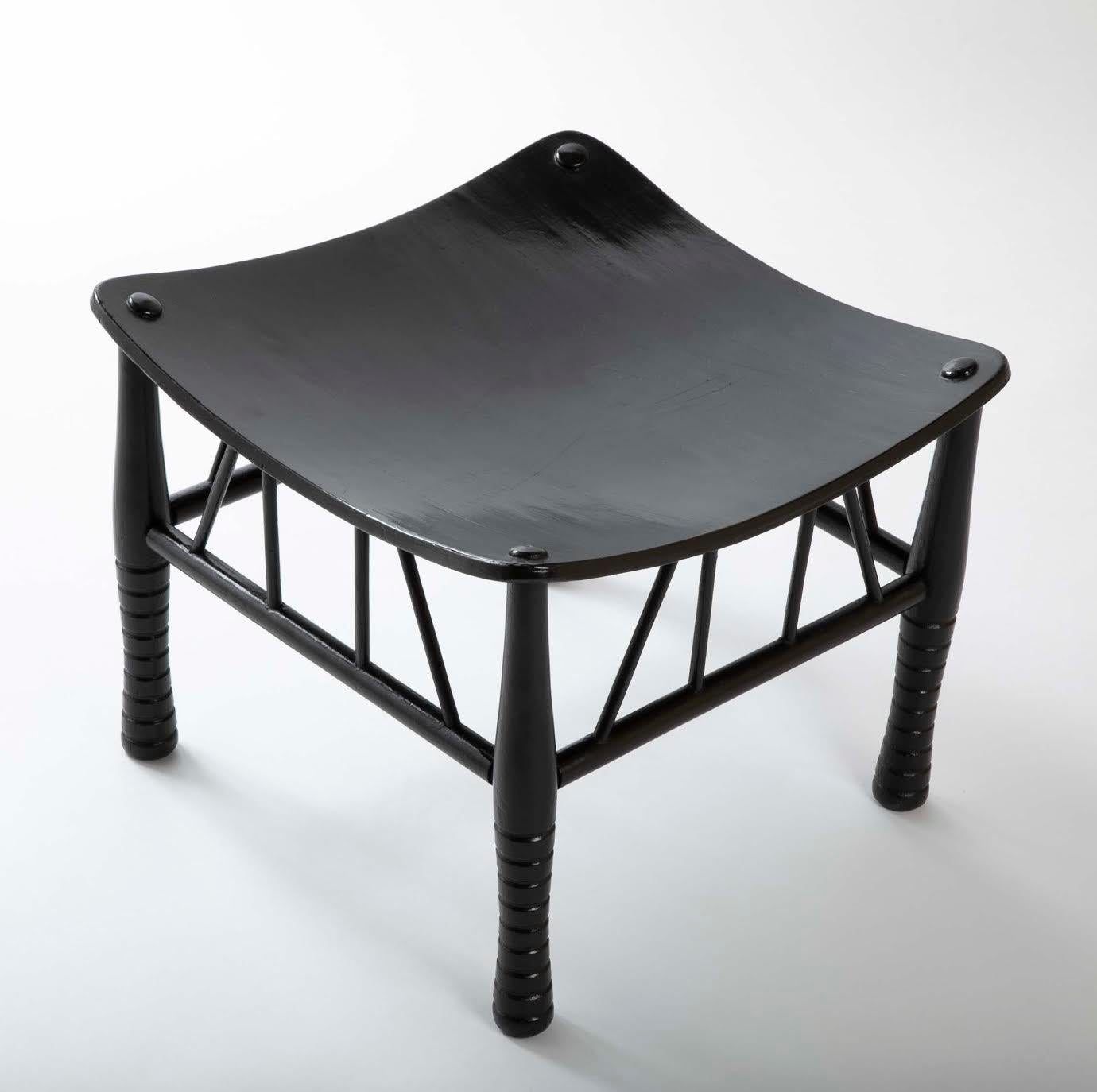 19th century English Thebes stool with ebonized lacquer finish, the solid seat supported by four turned legs united by stretchers. A fine example of the form, unusual in it's rich black surface. The original Egyptian Thebes stool dates back to the