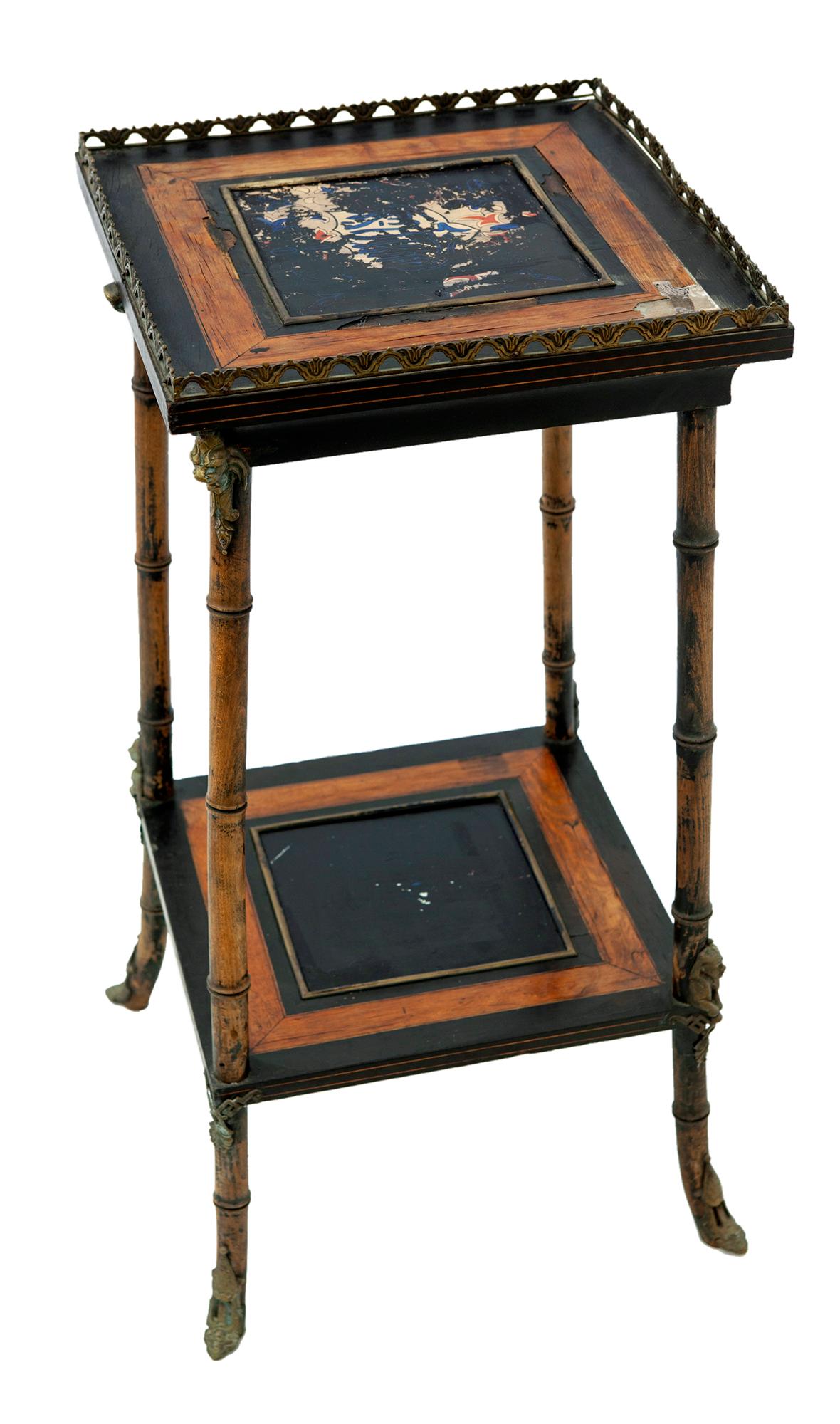 This stand has faux bamboo legs, a funky painted tile with Arabic writing lies below a black painted tile.
There is a lower shelf.
The bronze/brass ormolu features eagle and intricate pieces on each corner.
There is a slight wiggle to the piece.
For