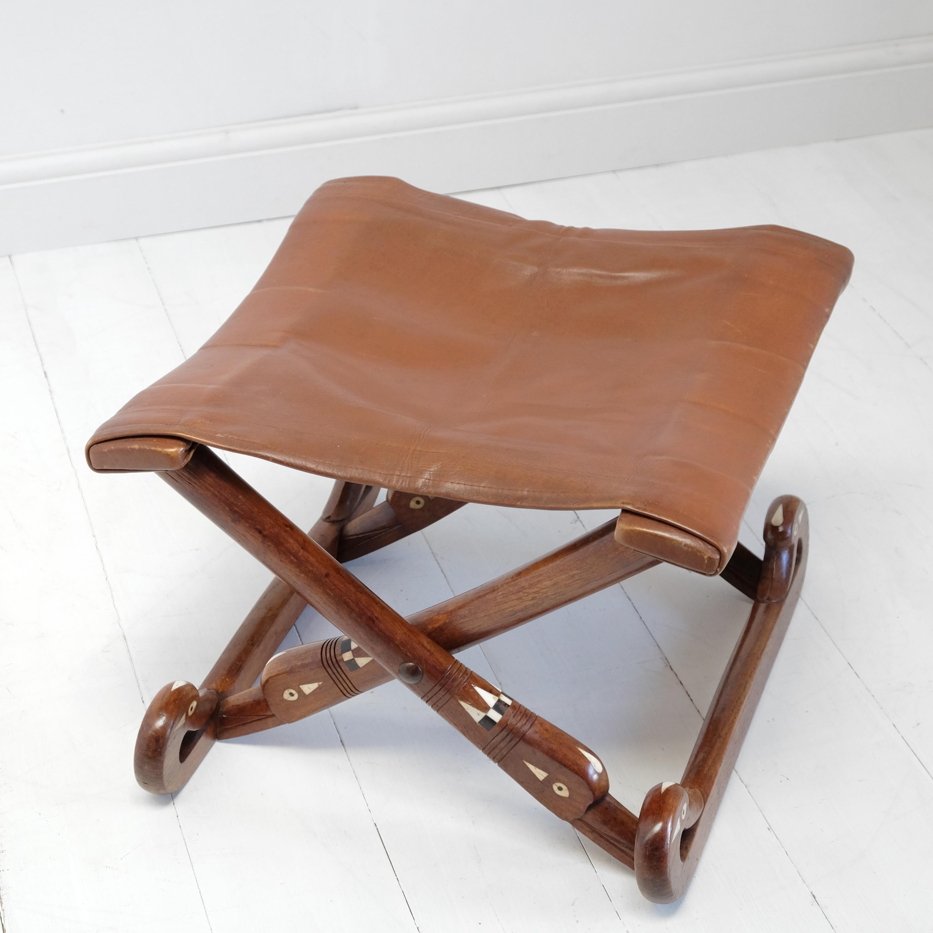 An exceptional and very interesting antique Egyptian Revival stool of the utmost quality and oozing style. Finely shaped oak frame with decorative ebony and bone inlay. Stylized swan form folding X-frame supports with a soft and comfortable quality