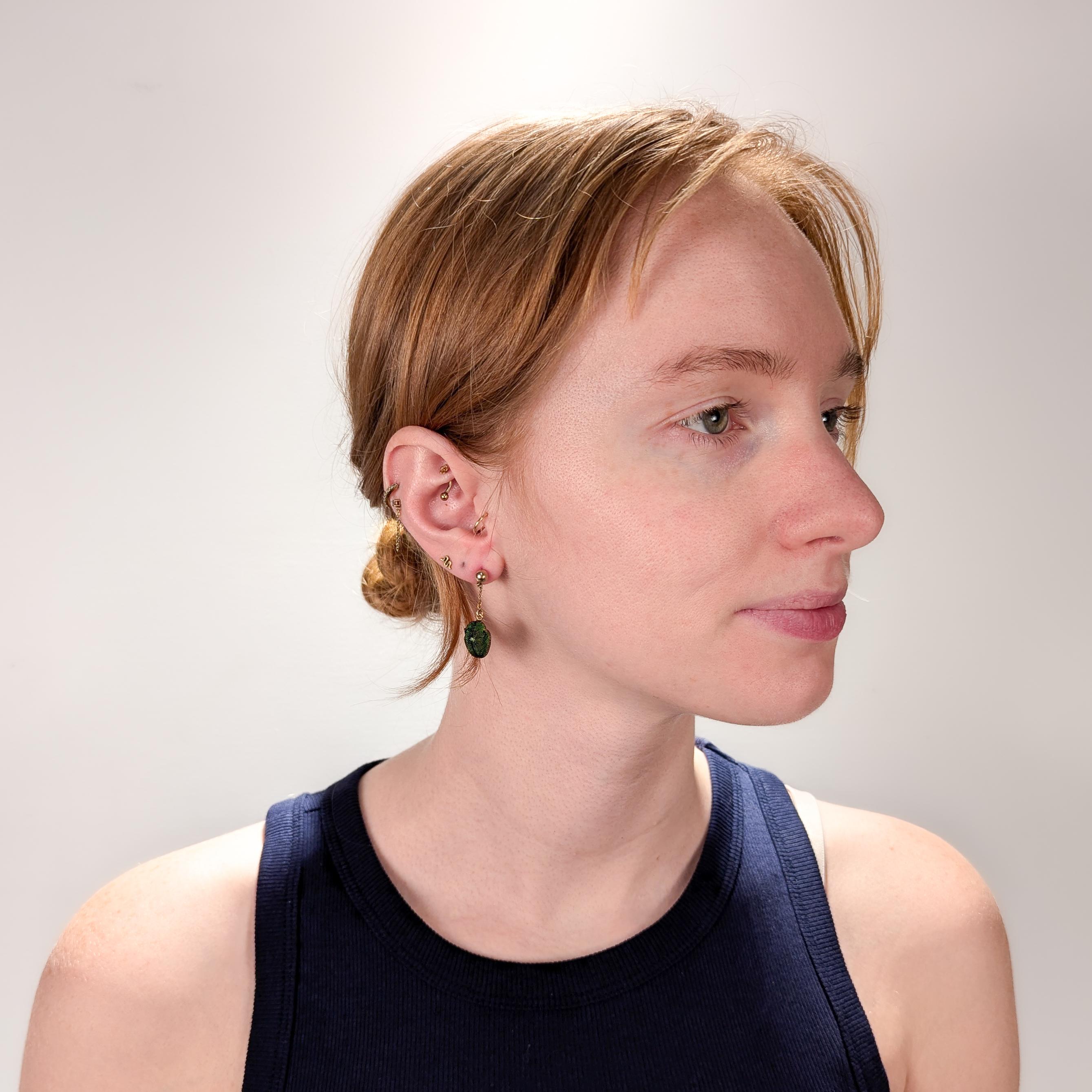 A fine pair of  gold and real scarab beetle earrings.

In 10 karat yellow gold.

Each with a real scarab beetle shell supported by a gold bead stud and a fine chain. 

Simply a wonderful pair of Egyptian Revival scarab earrings!

Date:
Late 19th or