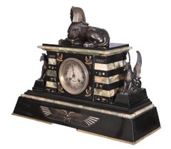 Egyptian Revival mantel garniture in black marble, green onyx, and gilt bronze