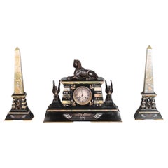 Egyptian Revival mantel garniture in black marble, green onyx, and gilt bronze