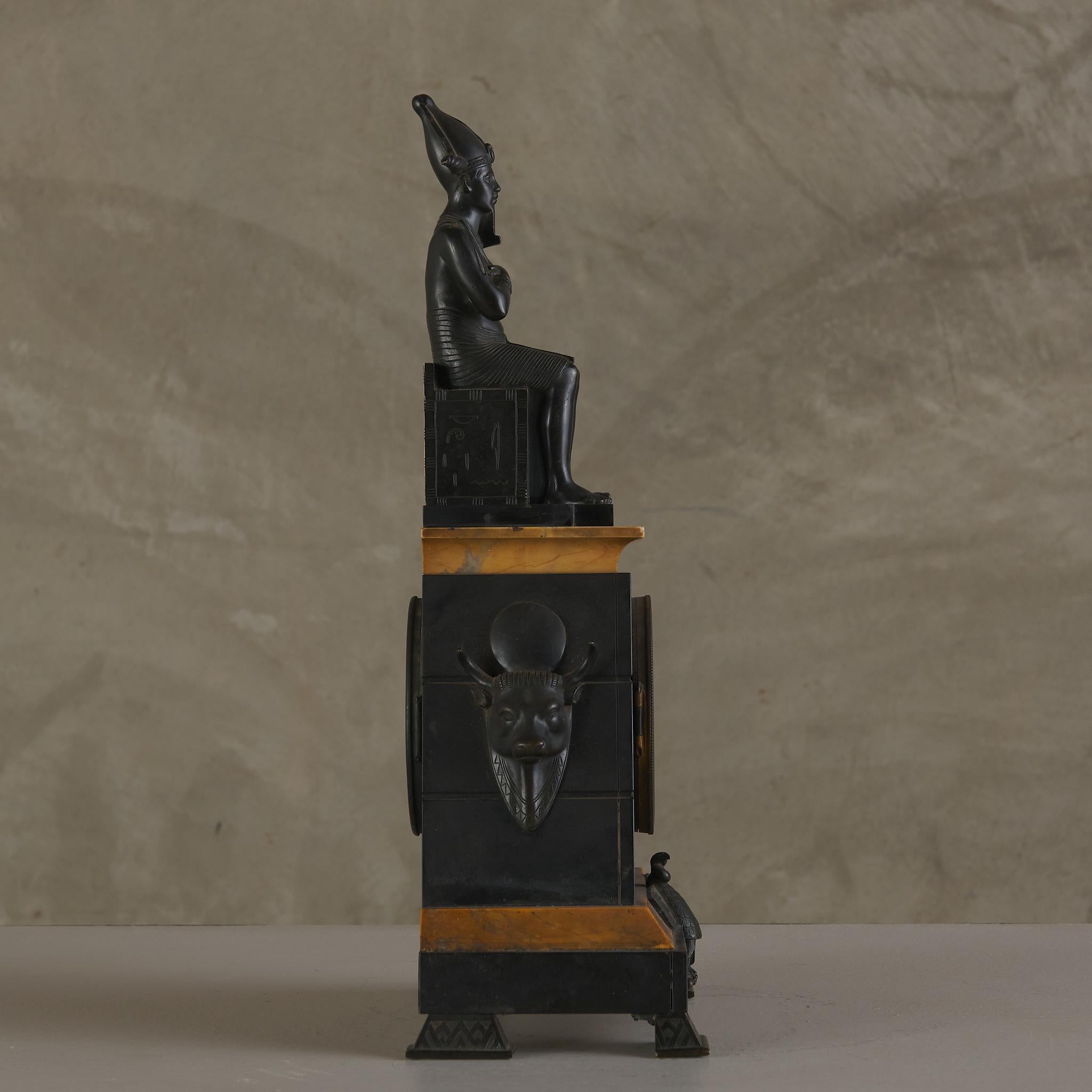 Carved Egyptian Revival Marble Clock with Two Candelabra Granitures For Sale