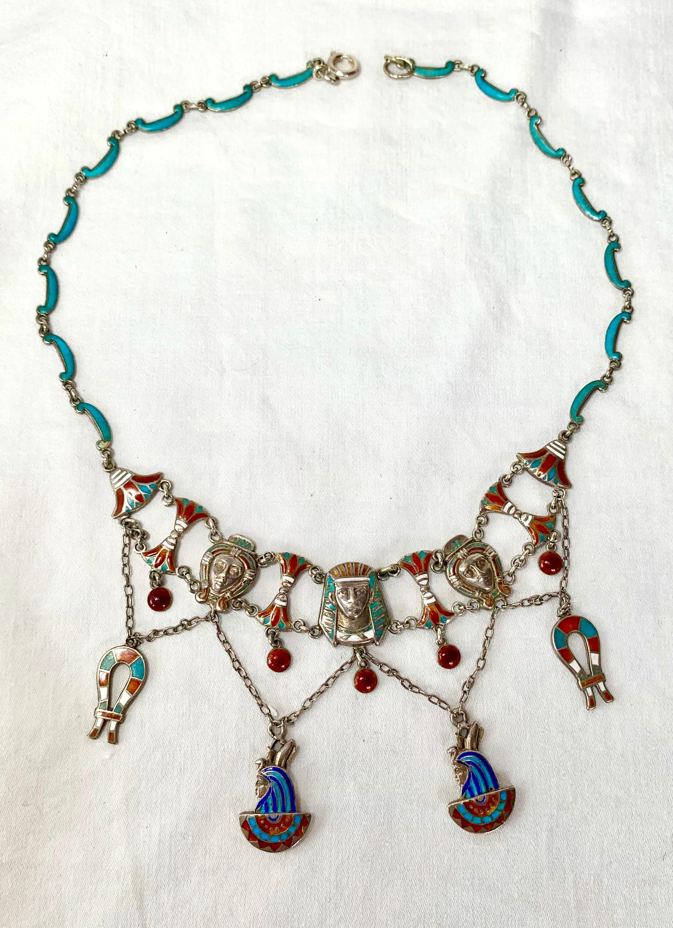This is a very rare antique Egyptian Revival Necklace in Silver with magnificent enamel work to create an Art Nouveau to Art Deco masterpiece!   The articulated necklace has images of Pharoah, Goddess, Lotus Flower, Hieroglyphics, and Goddess with a