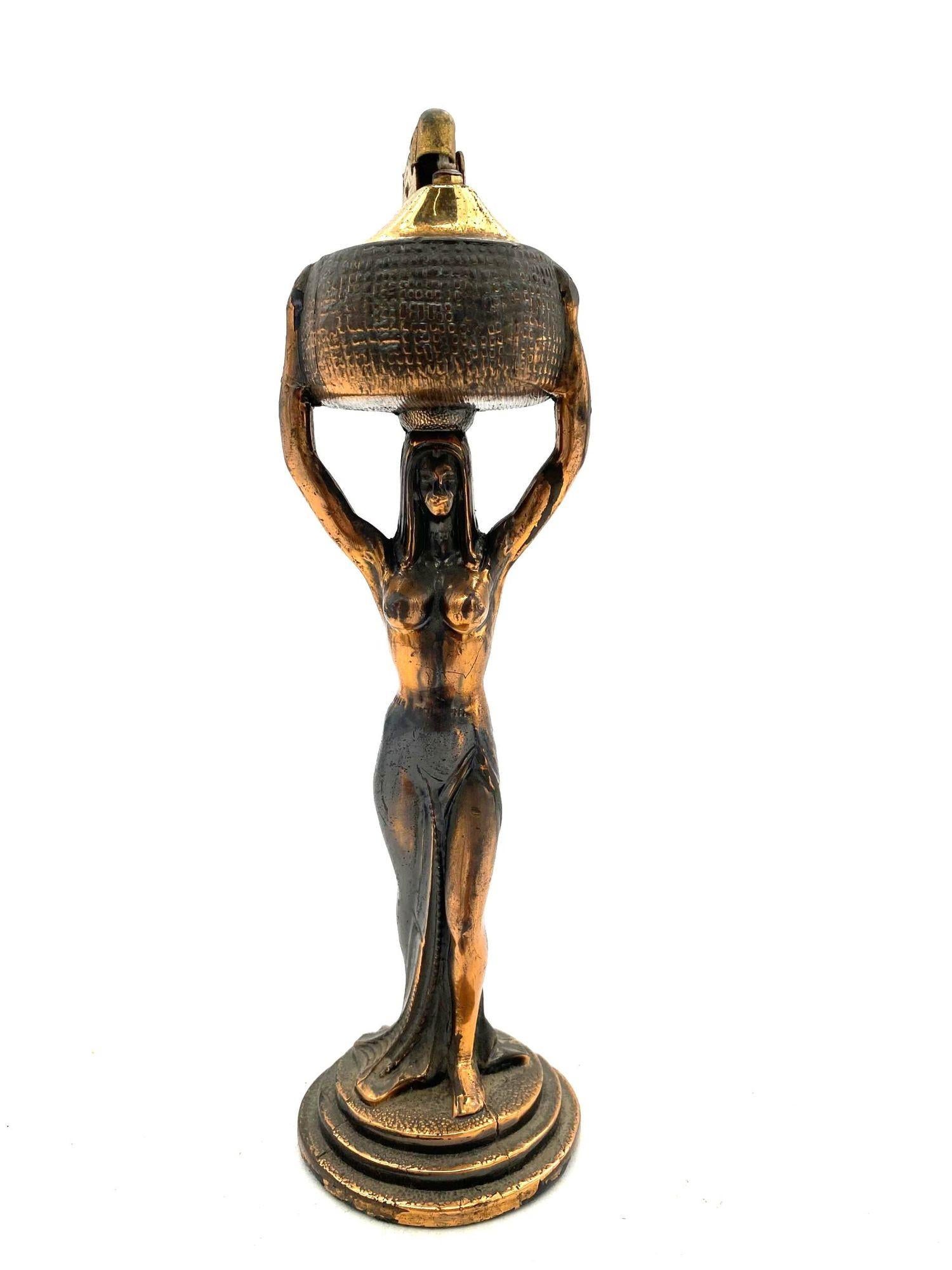 Art Deco era copper Egyptian Revival nude queen Table Lighter featuring a figural lighter with a removable lighter at the top.
1920, United States, comes empty and ready for use.
